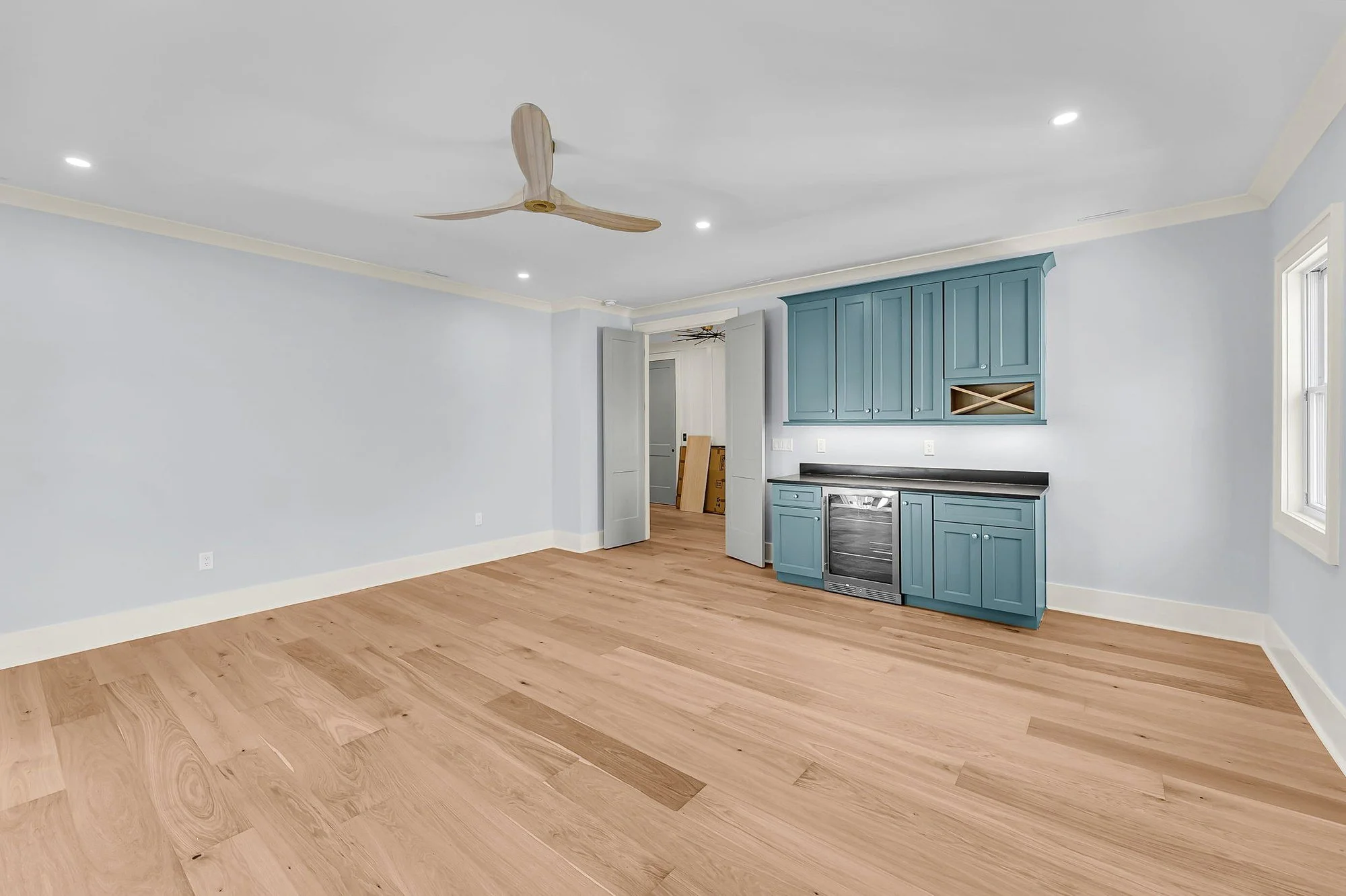 Upstairs media room with custom wet bar in an Isle of Palms SC home by Iconic Developments