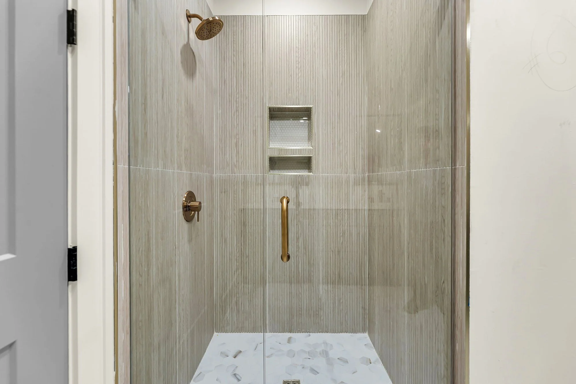 Guest bath with fluted tile shower surround in an Isle of Palms SC custom home build