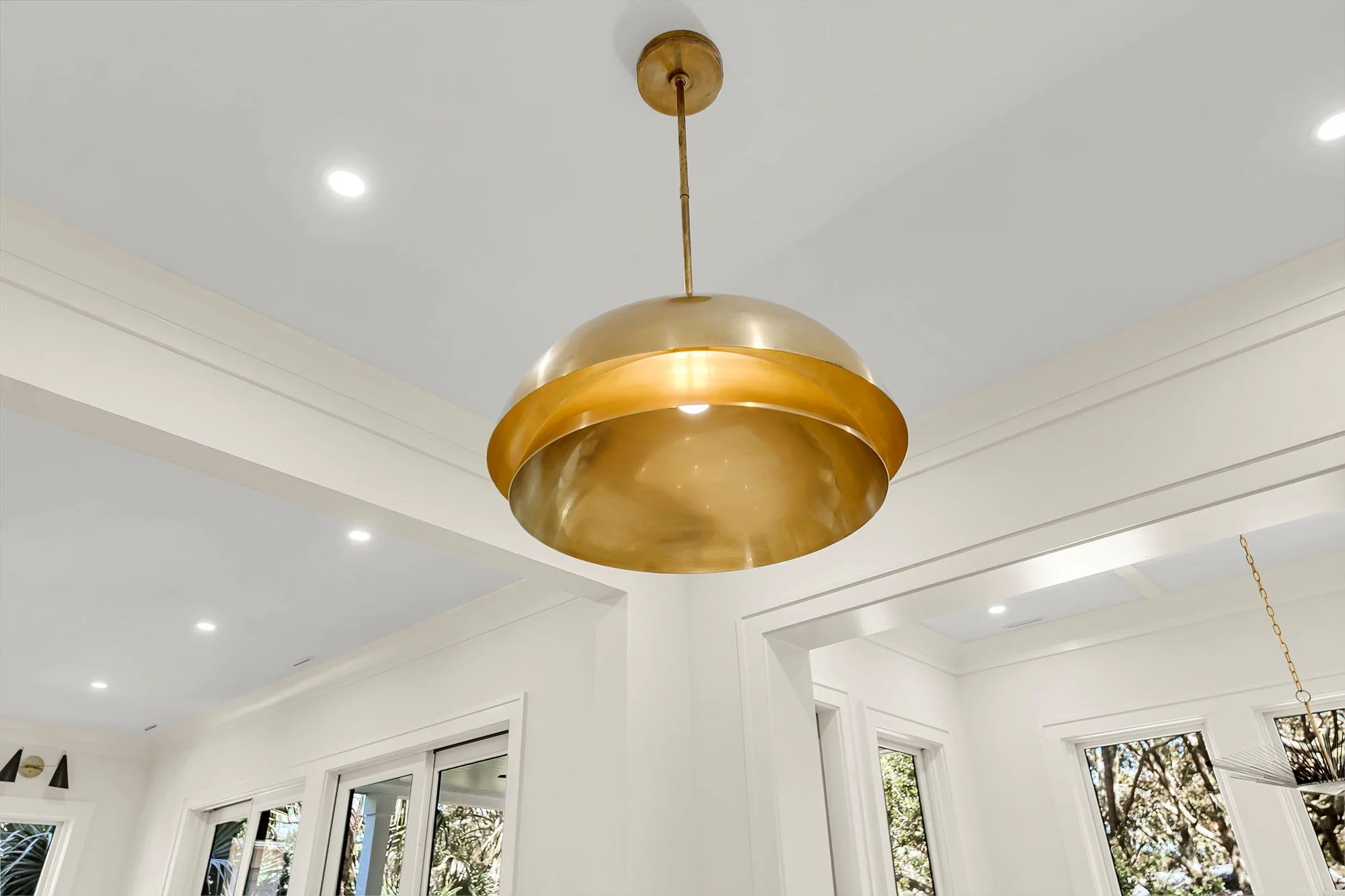 Brass dome pendant lighting detail in a coastal Charleston SC custom kitchen build