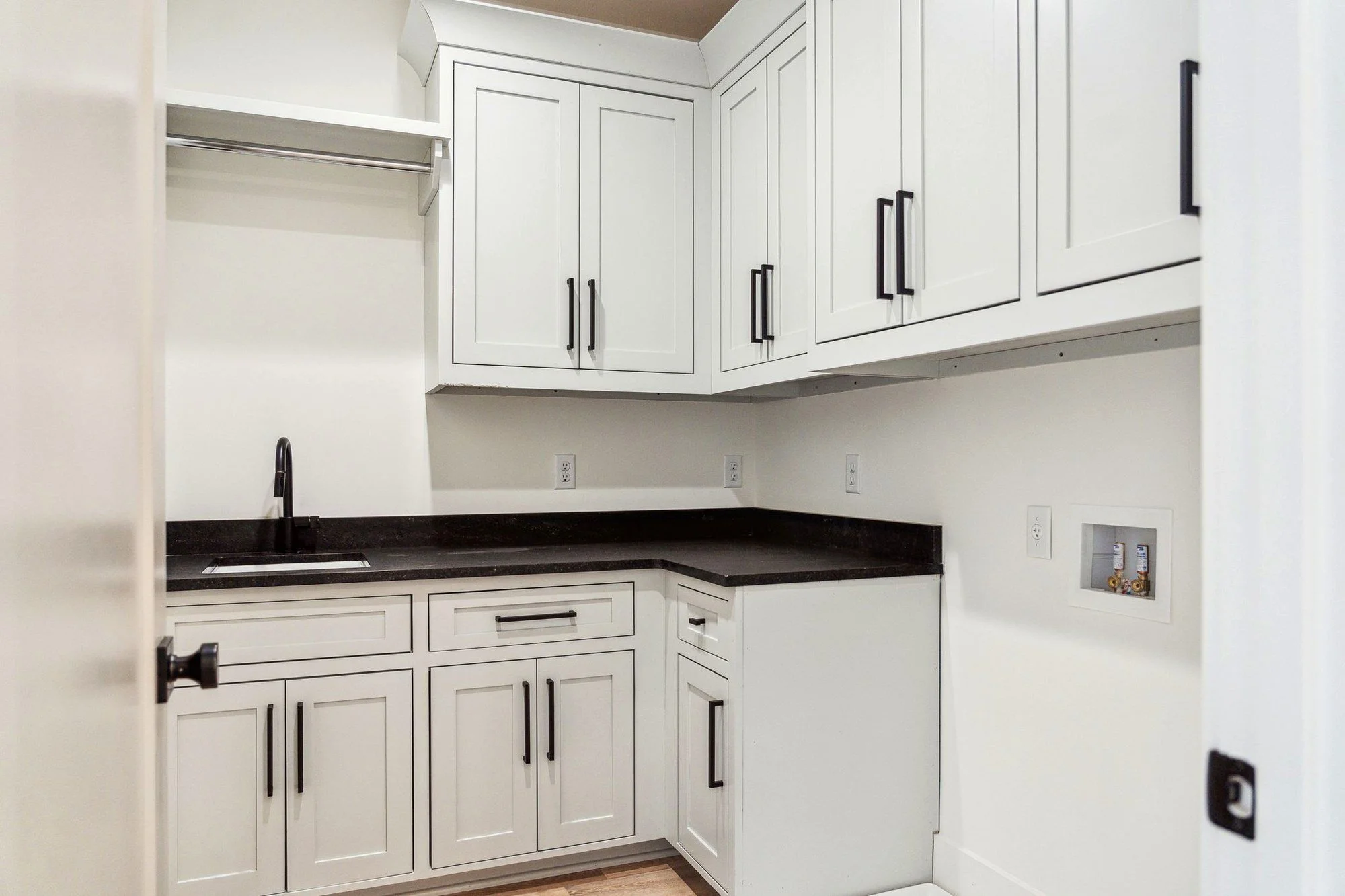 Custom laundry room with shaker cabinetry and stone counters in a Daniel Island SC home