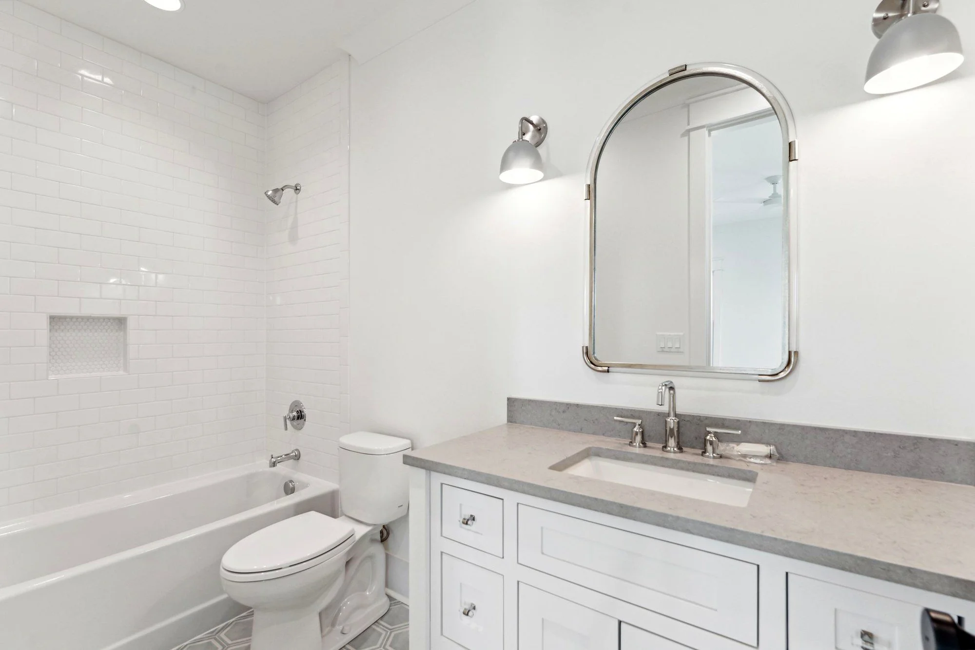 Guest bathroom with subway tile tub surround and quartz vanity in Daniel Island SC