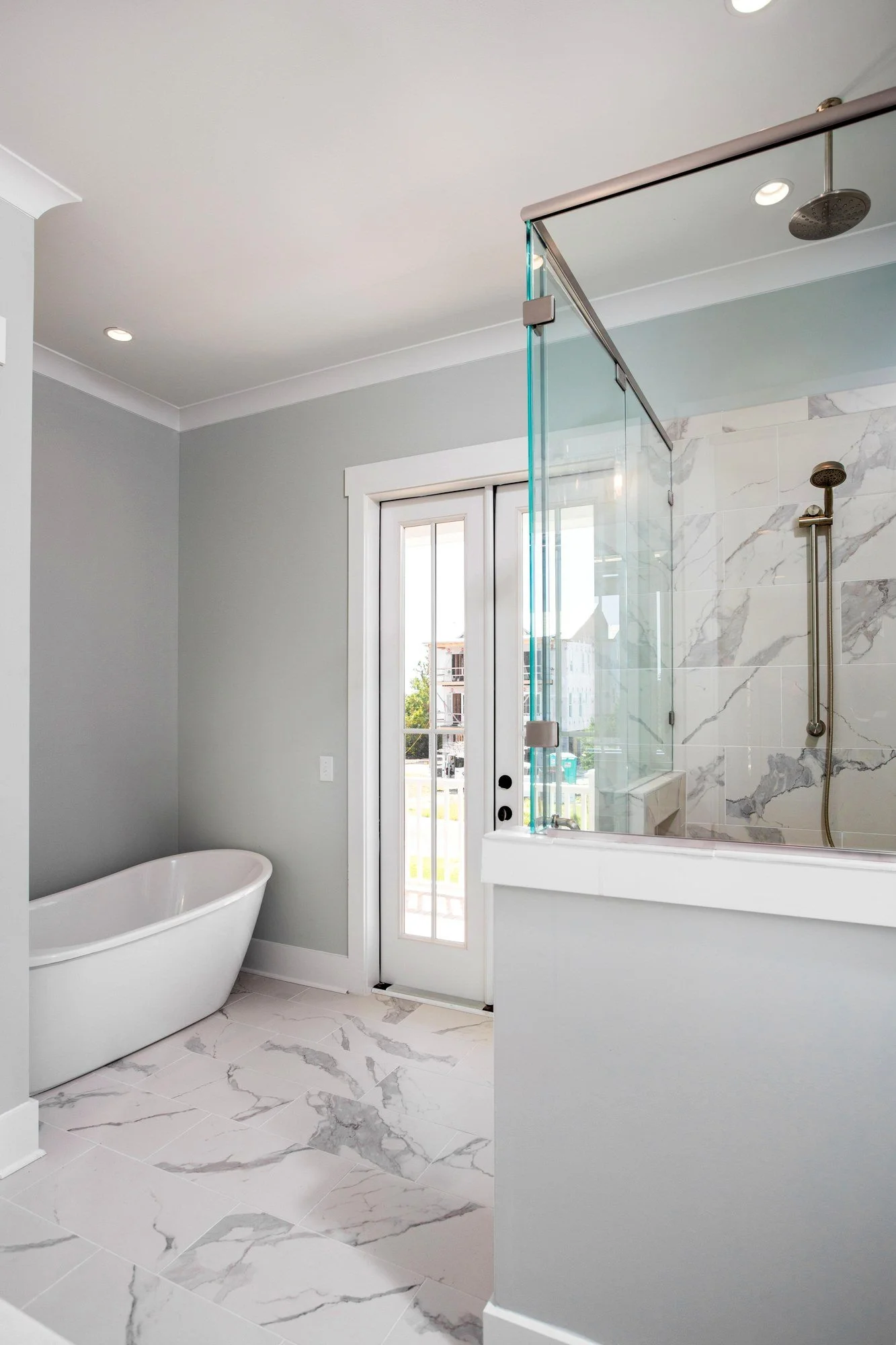 Owners bath with a soaking tub and marble shower in a Johns Island SC custom home build