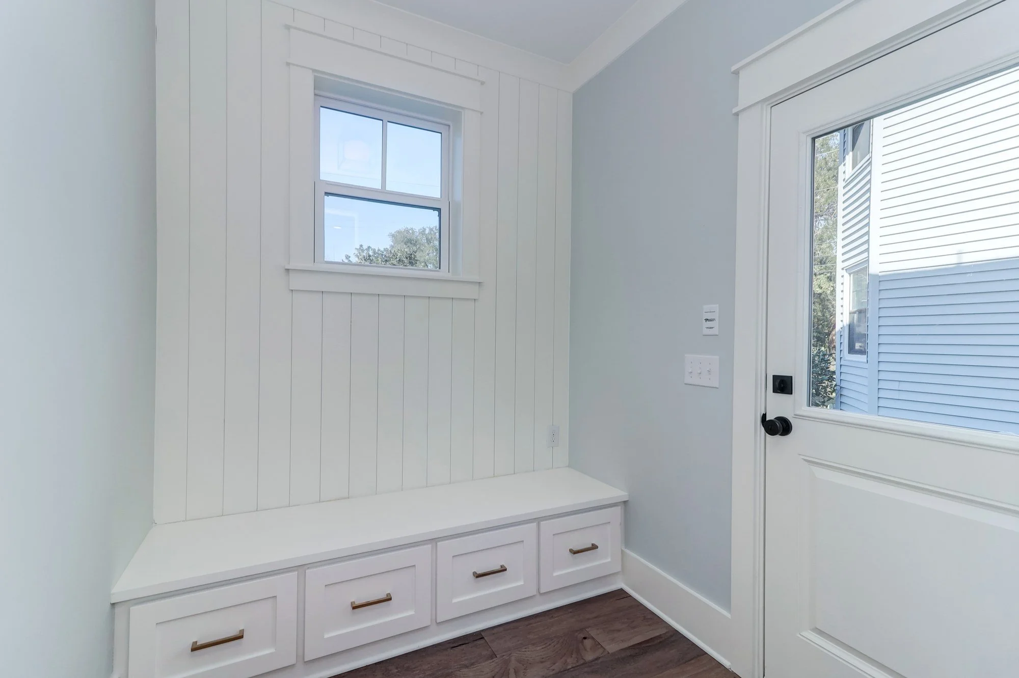 Mudroom drop zone with built-in bench in an Old Village Mount Pleasant SC custom home