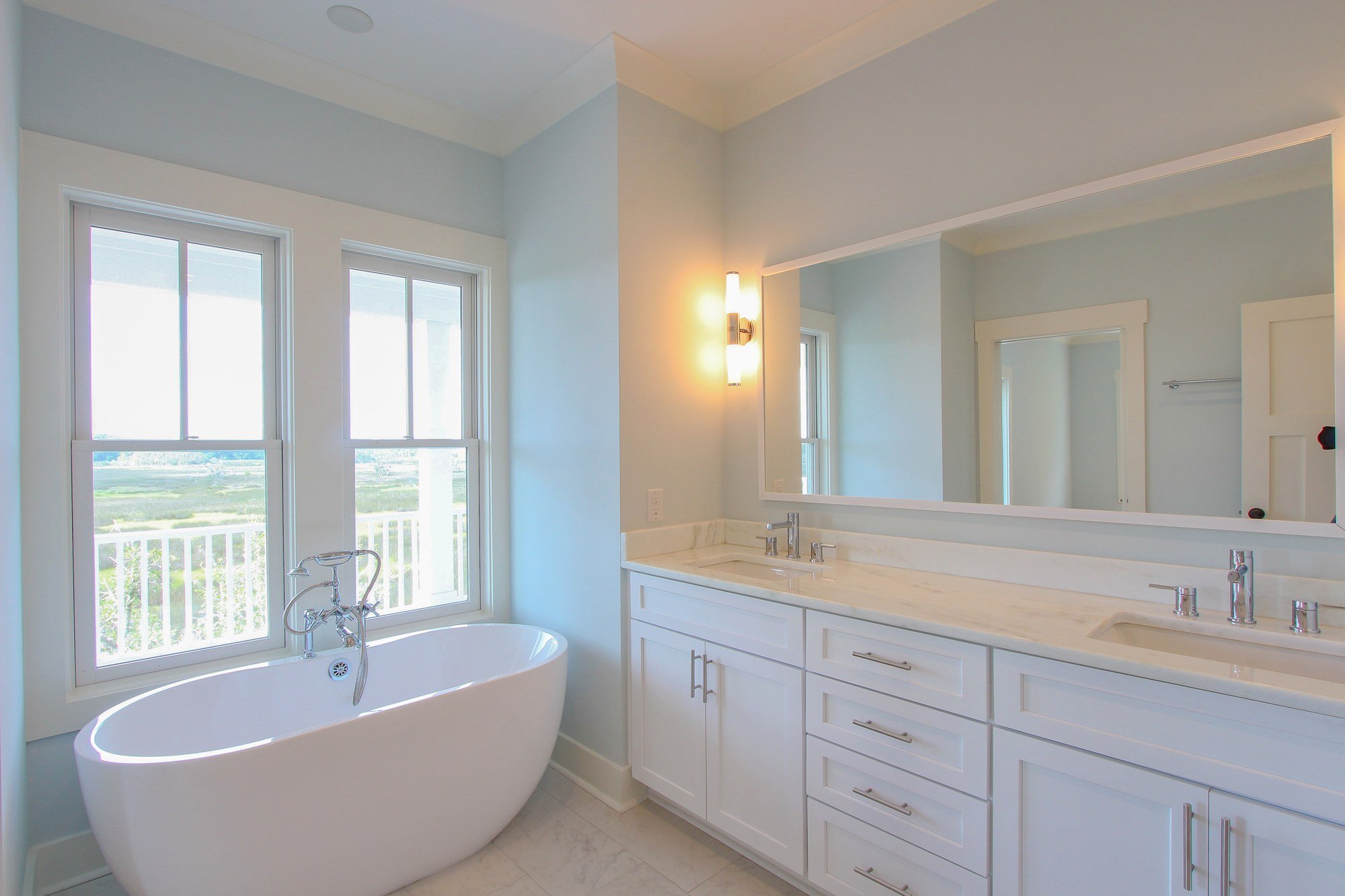 Primary bathroom soaking tub positioned with marsh views in Charleston SC
