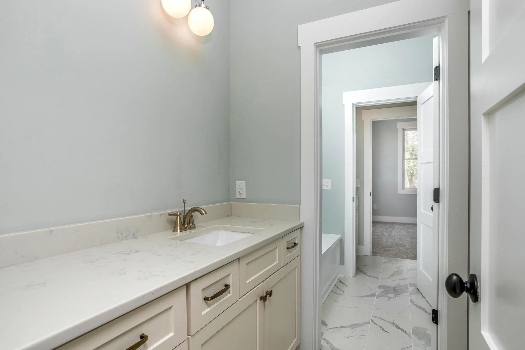 Guest bath with a quartz vanity top in a Charleston SC home by Iconic Developments