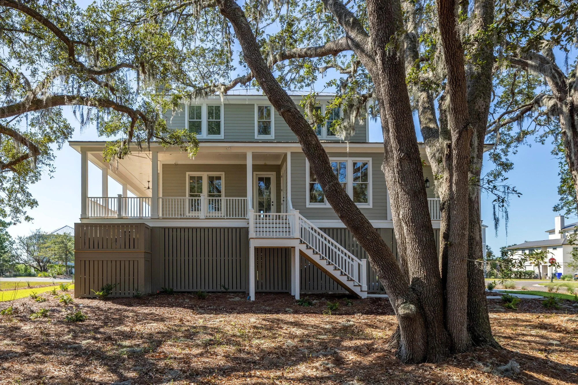 Side elevation shaded by live oaks at a custom Charleston SC Lowcountry home build