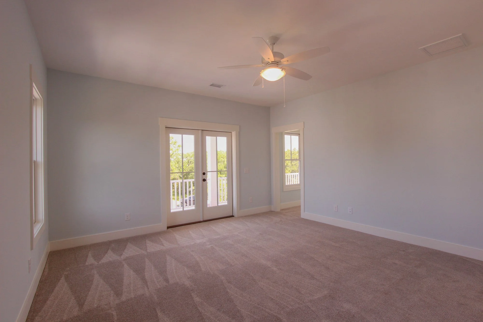 Guest bedroom with French doors to the porch in a Johns Island SC custom home