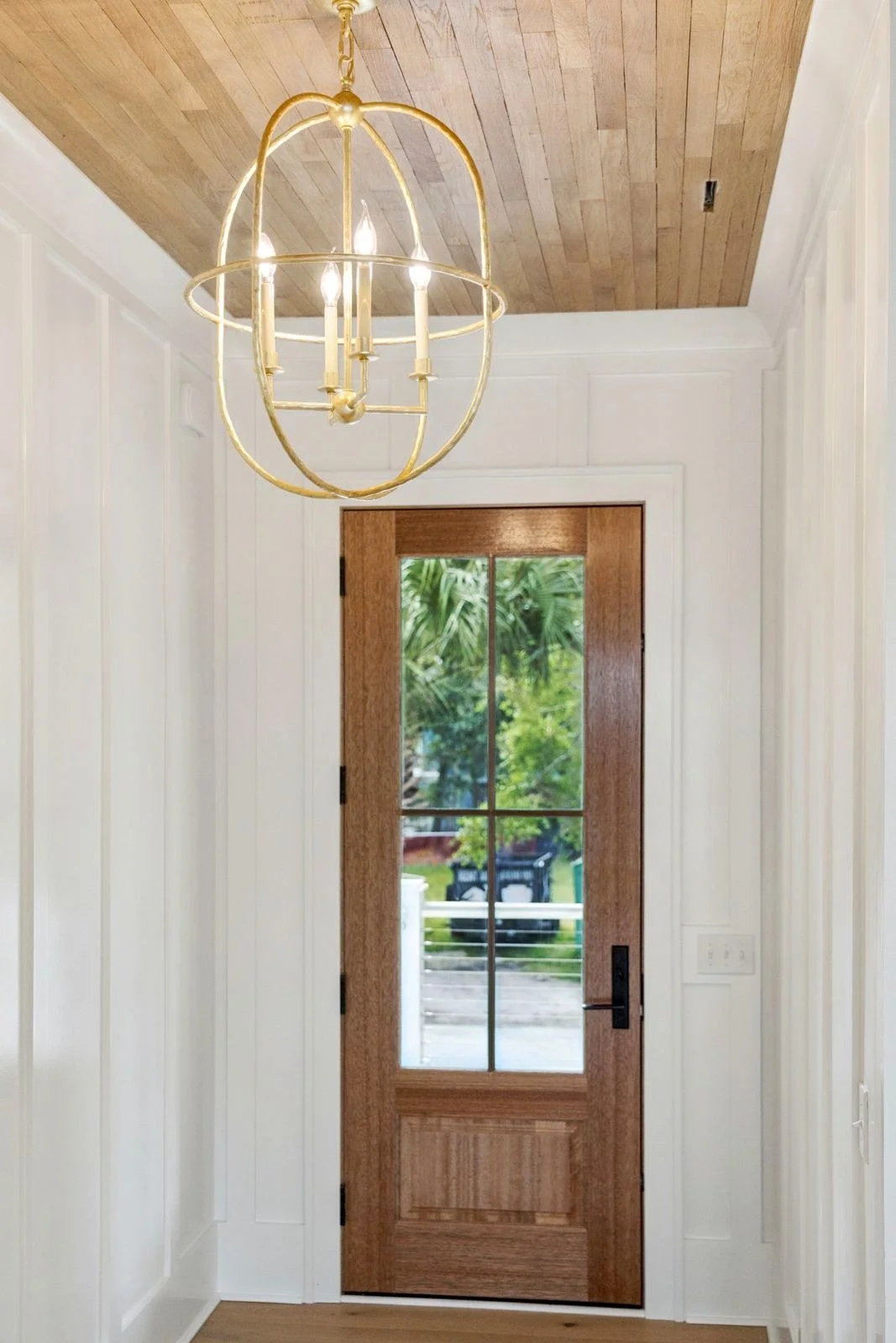 Two-story foyer with orb chandelier in an elevated Isle of Palms SC custom home build