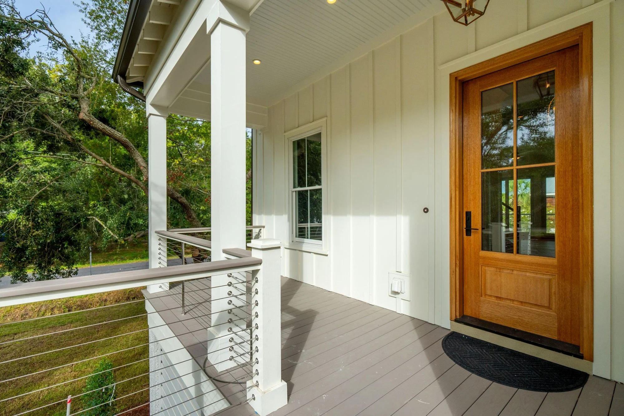 Mahogany front door on the covered front porch of an Isle of Palms SC luxury home build