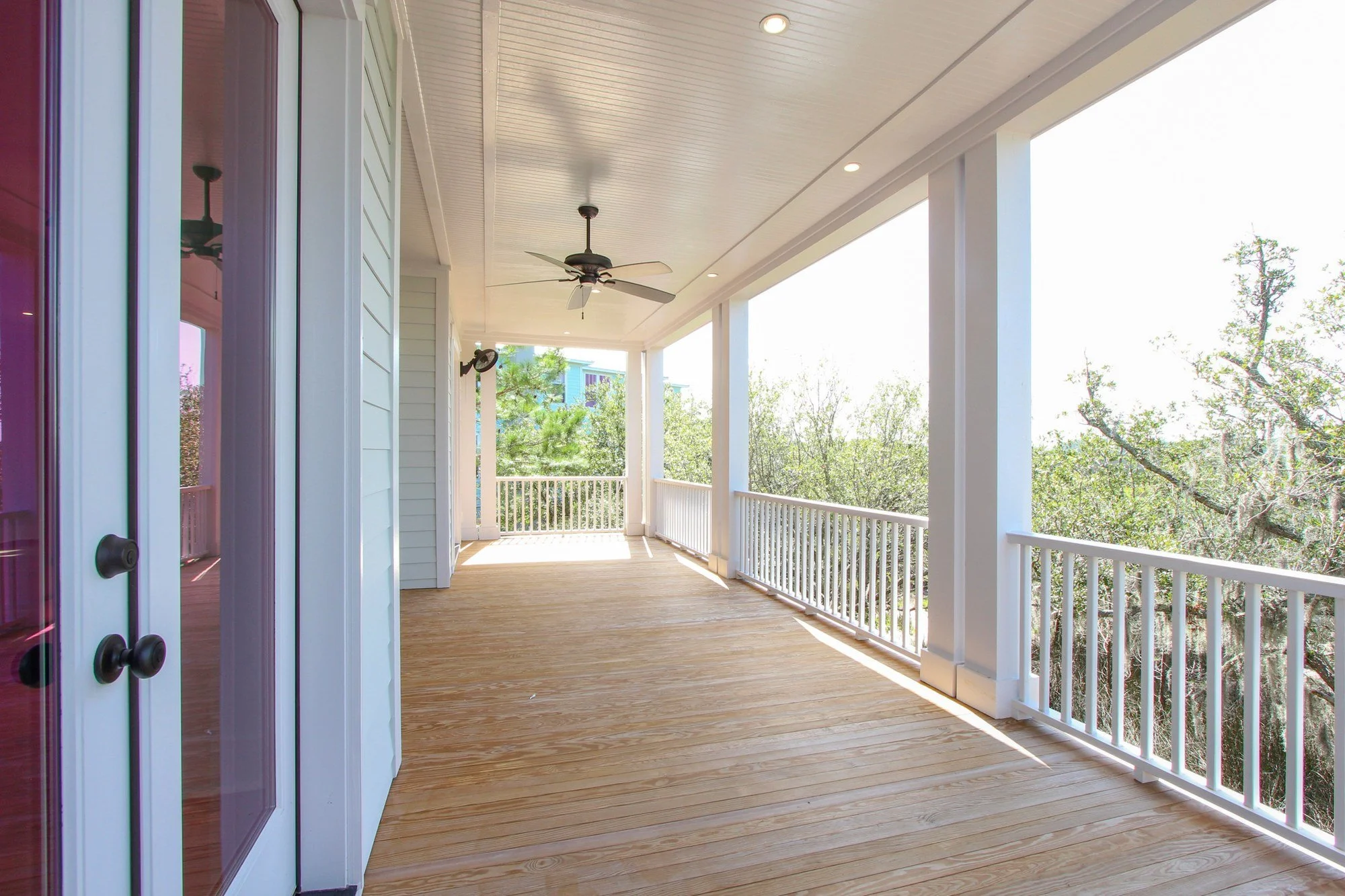 Screened porch doors with treetop and marsh views on Johns Island in Charleston SC