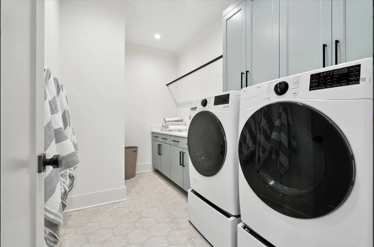 Upstairs laundry room with custom cabinetry in an Isle of Palms SC luxury home build