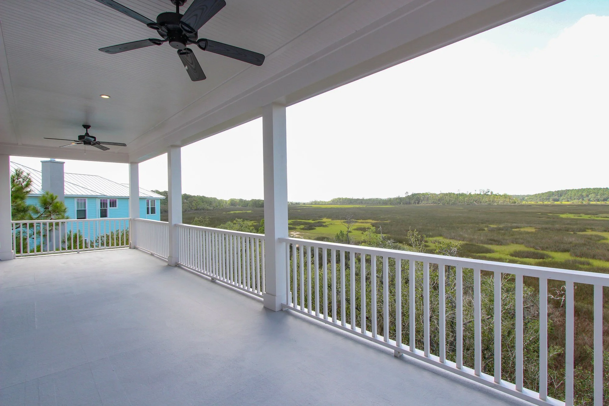 Covered rear porch with heart pine decking overlooking Charleston SC marshland