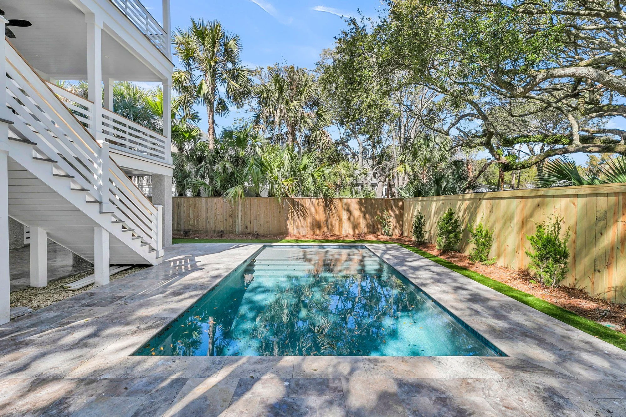 Backyard pool and covered ground-level terrace on Isle of Palms SC by Iconic Developments