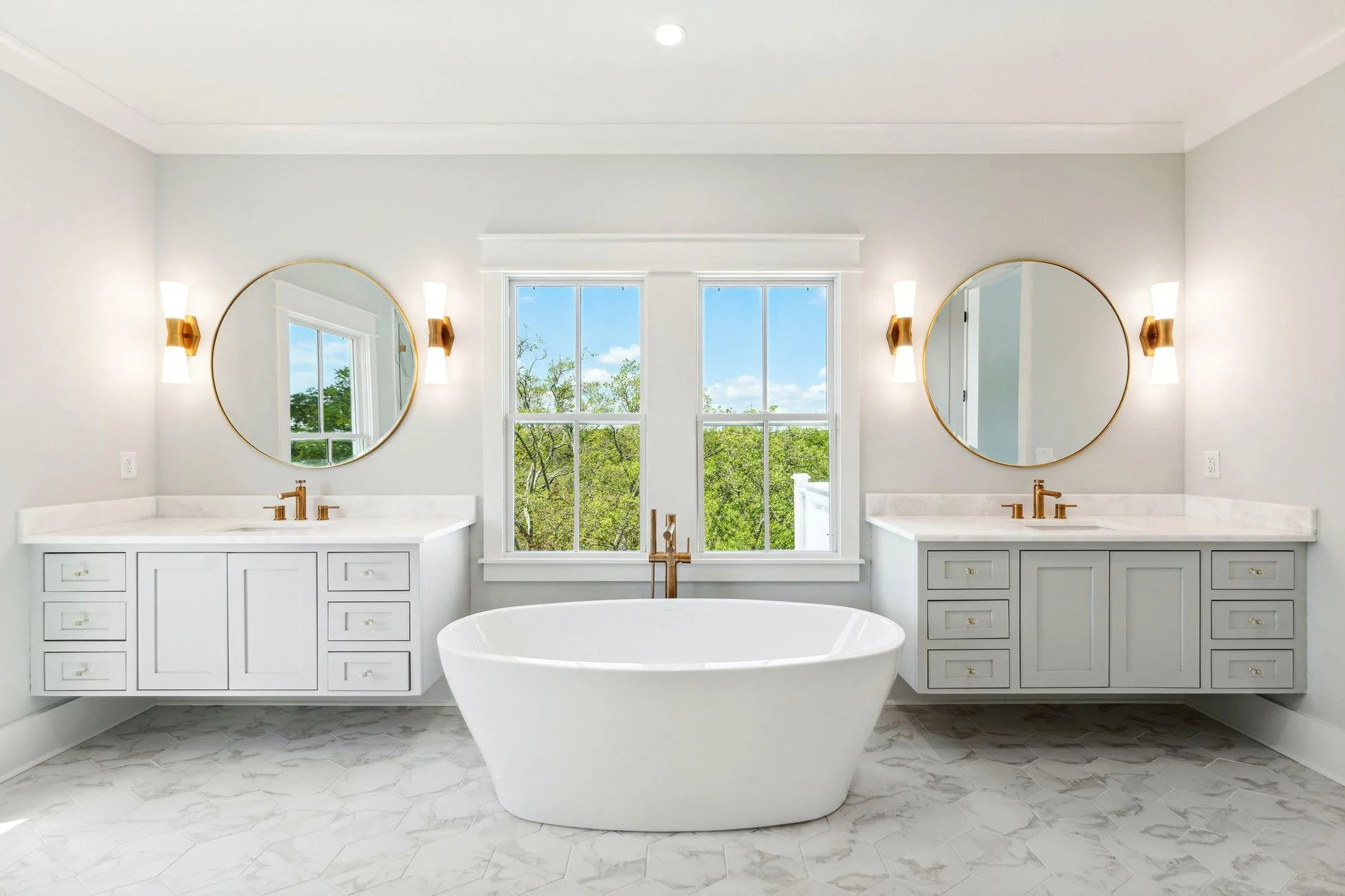 Primary bathroom with dual vanities and freestanding tub in a Daniel Island SC custom home