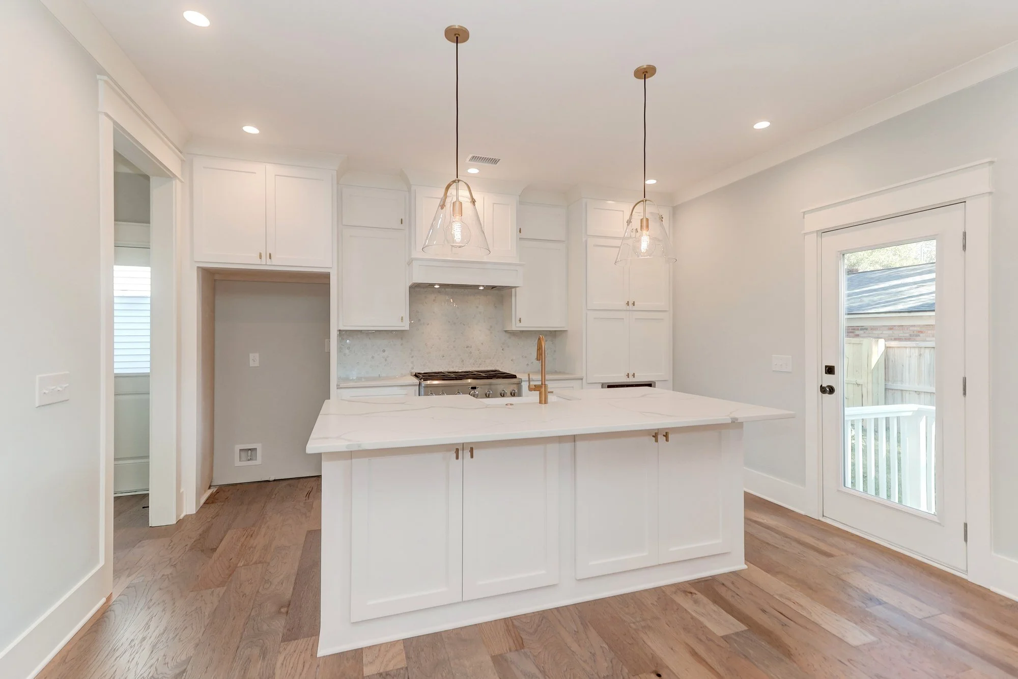 Kitchen island and professional range in a Mount Pleasant SC home by Iconic Developments