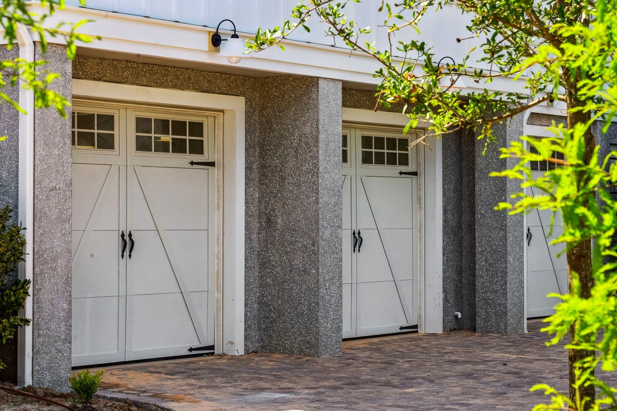 Carriage garage doors and paver driveway on a Daniel Island SC custom home by Iconic Developments