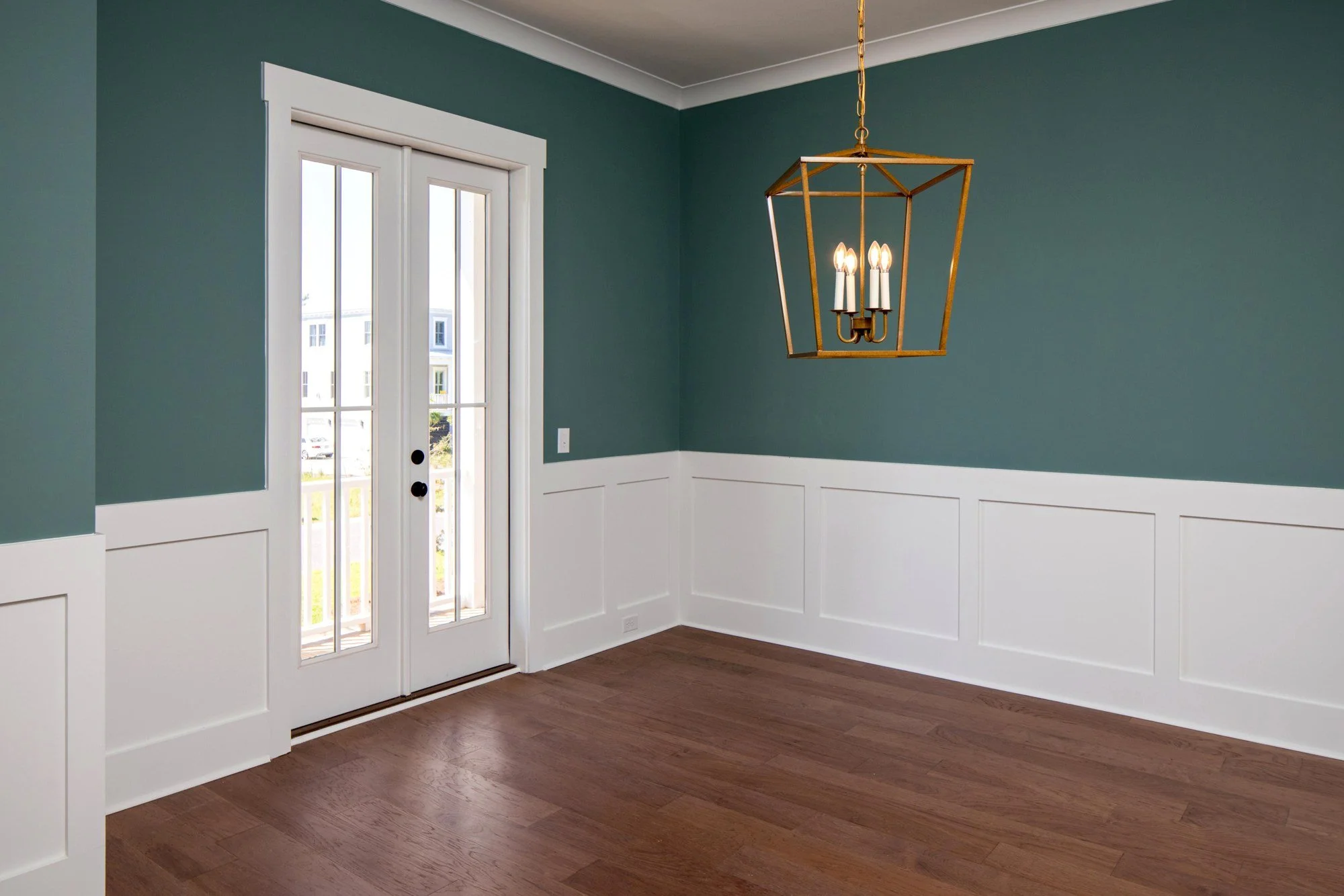 Dining room with a brass lantern pendant in a Johns Island SC luxury custom home build