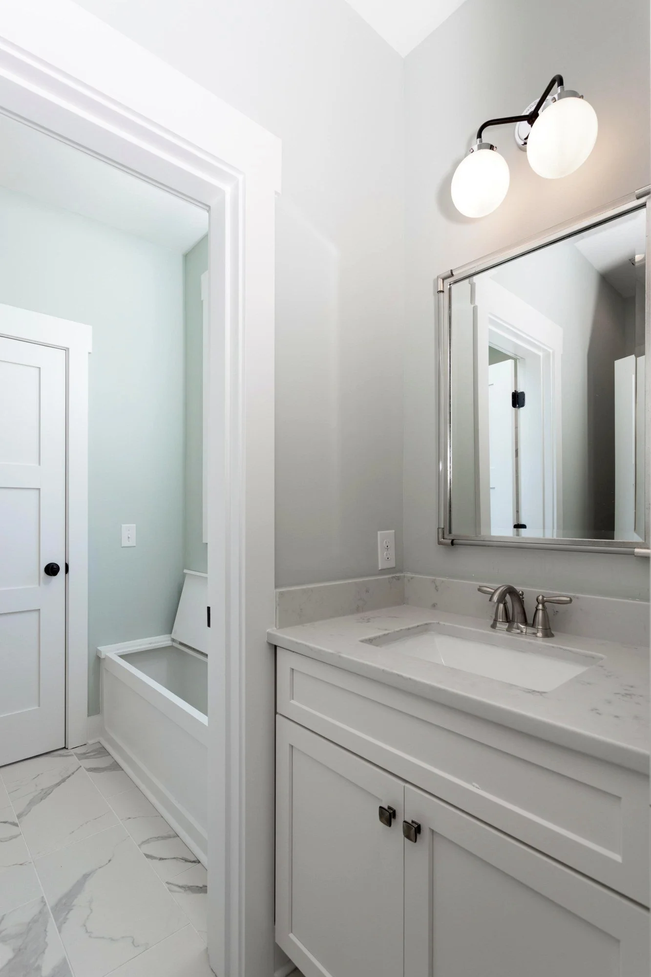Guest bath vanity with a framed mirror in a Johns Island SC luxury custom home build