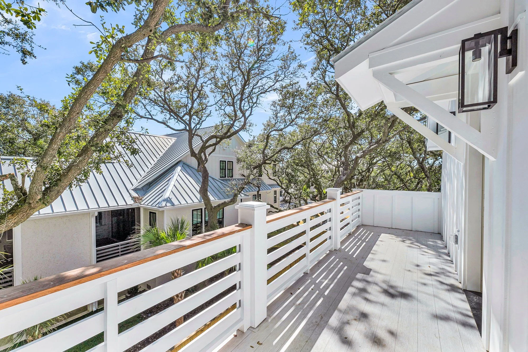 Deep covered front porch on an elevated Isle of Palms SC custom home by Iconic Developments