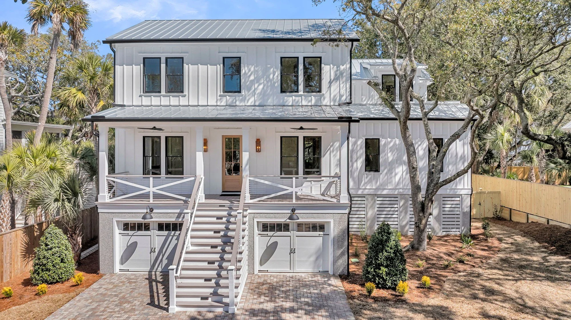 Double front porches with board-and-batten siding on an Isle of Palms SC custom home build