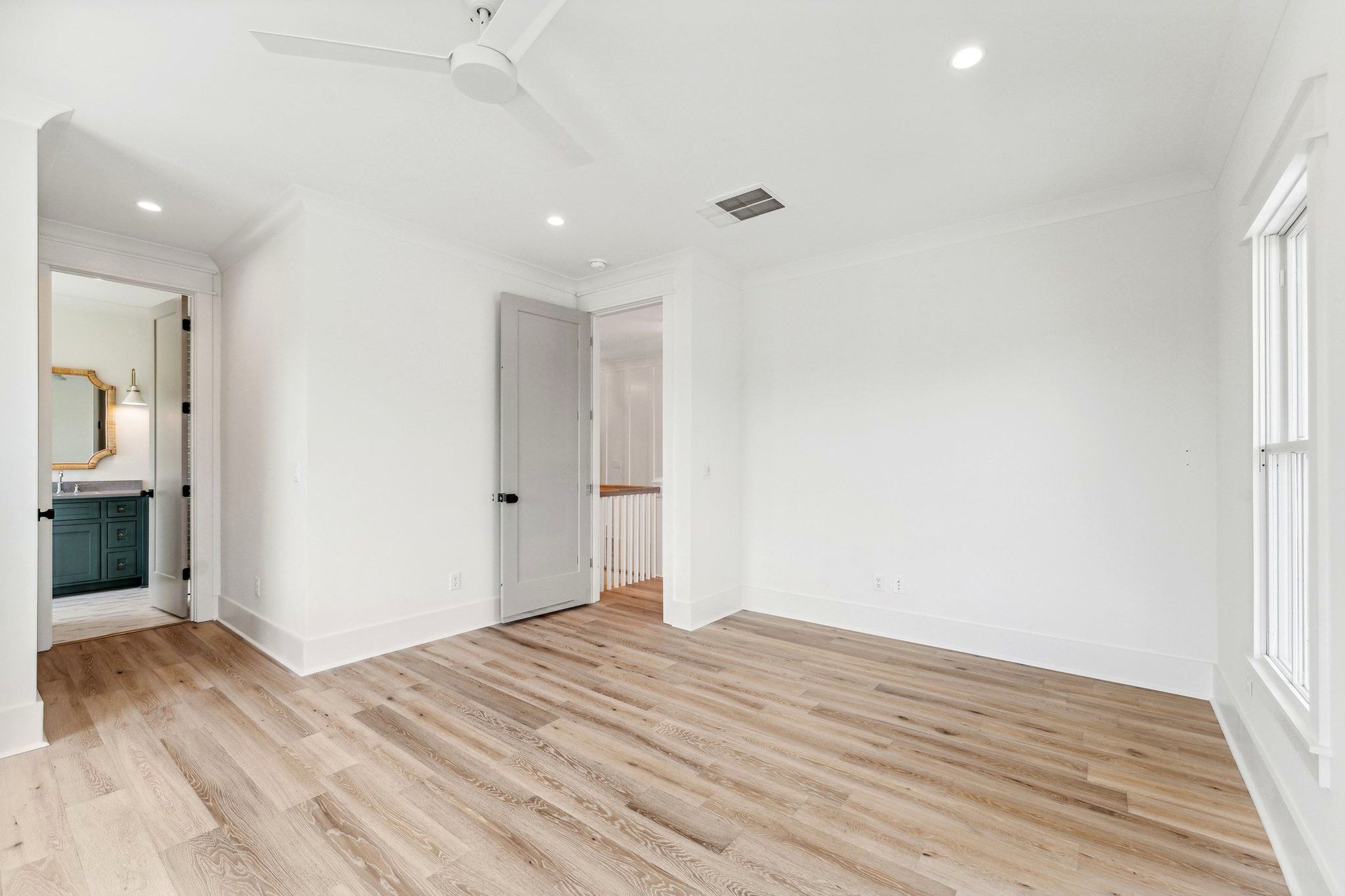 Bedroom opening to a private en-suite bath in a Charleston SC luxury custom home build