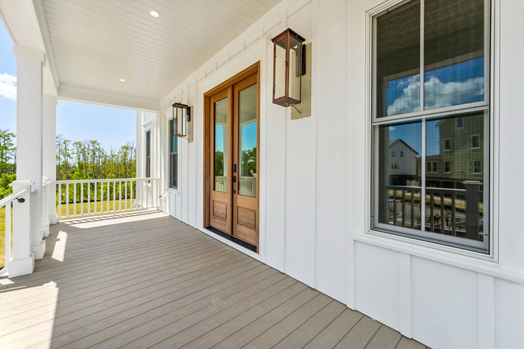 Deep front porch with square columns on a custom Daniel Island SC luxury home build