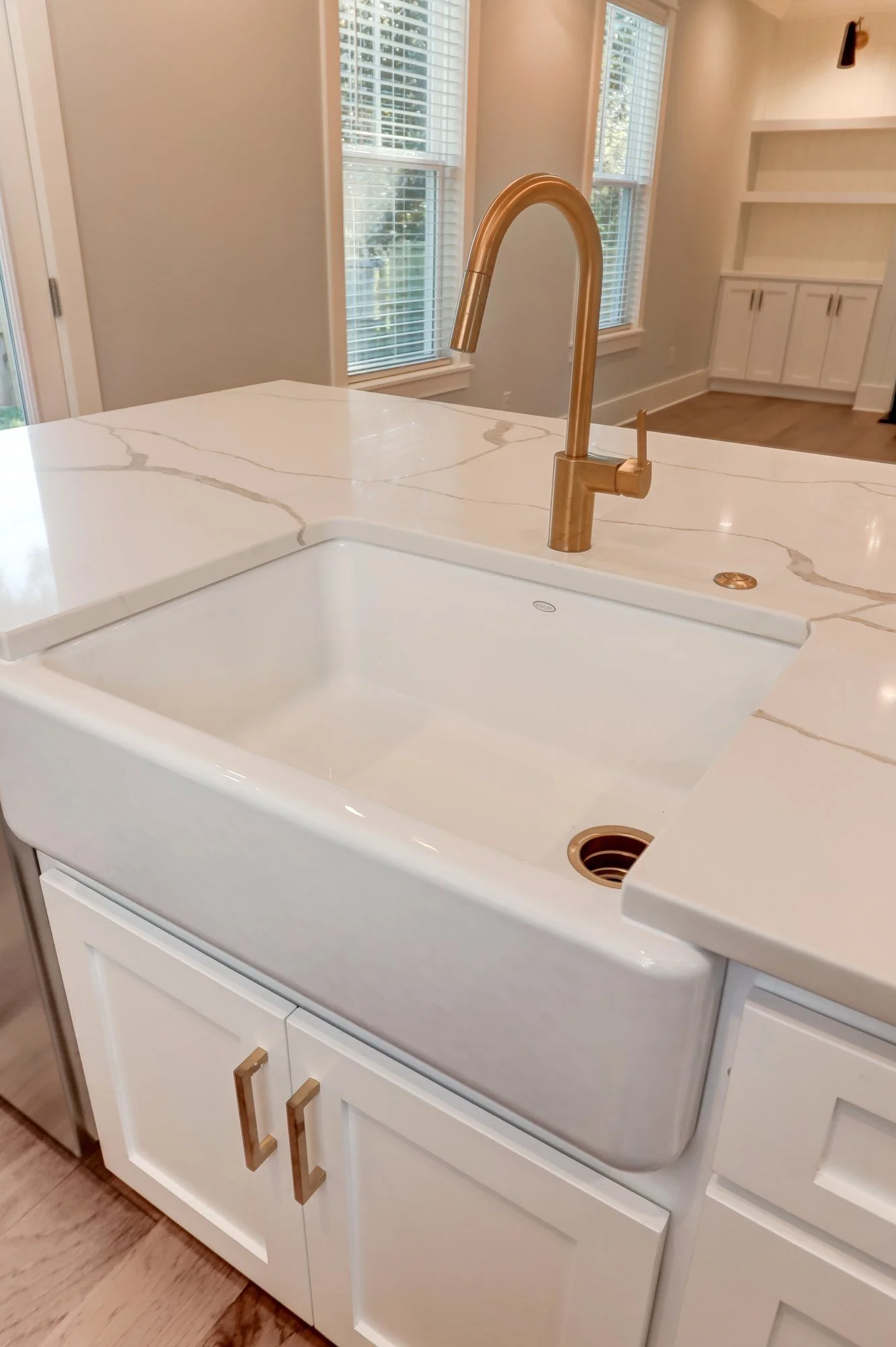 Farmhouse sink with brass faucet in an Old Village Mount Pleasant SC custom kitchen