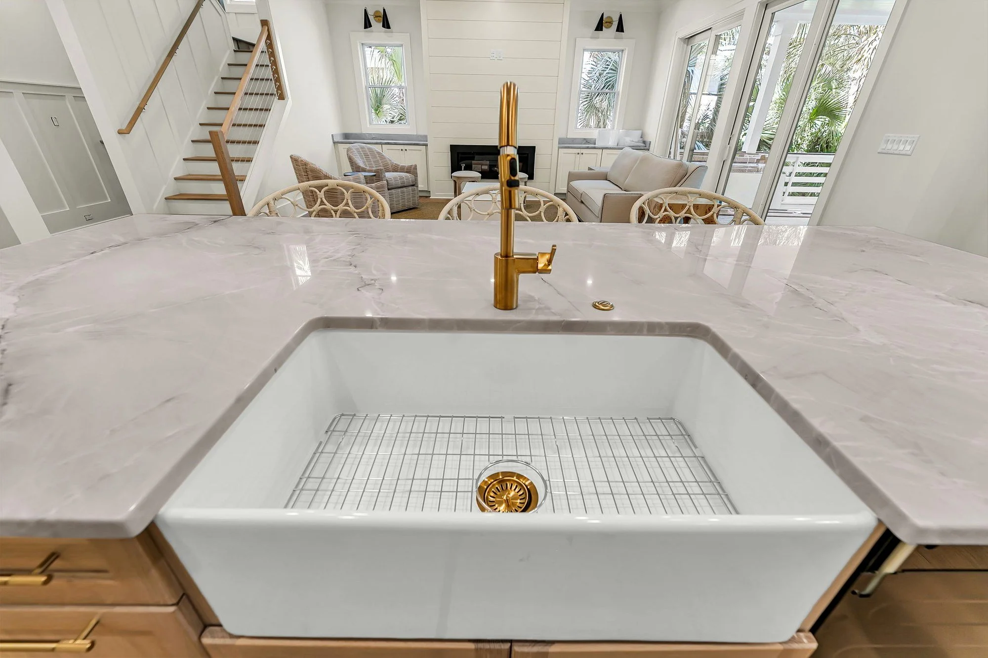 Farmhouse sink with unlacquered brass faucet in an Isle of Palms SC custom kitchen