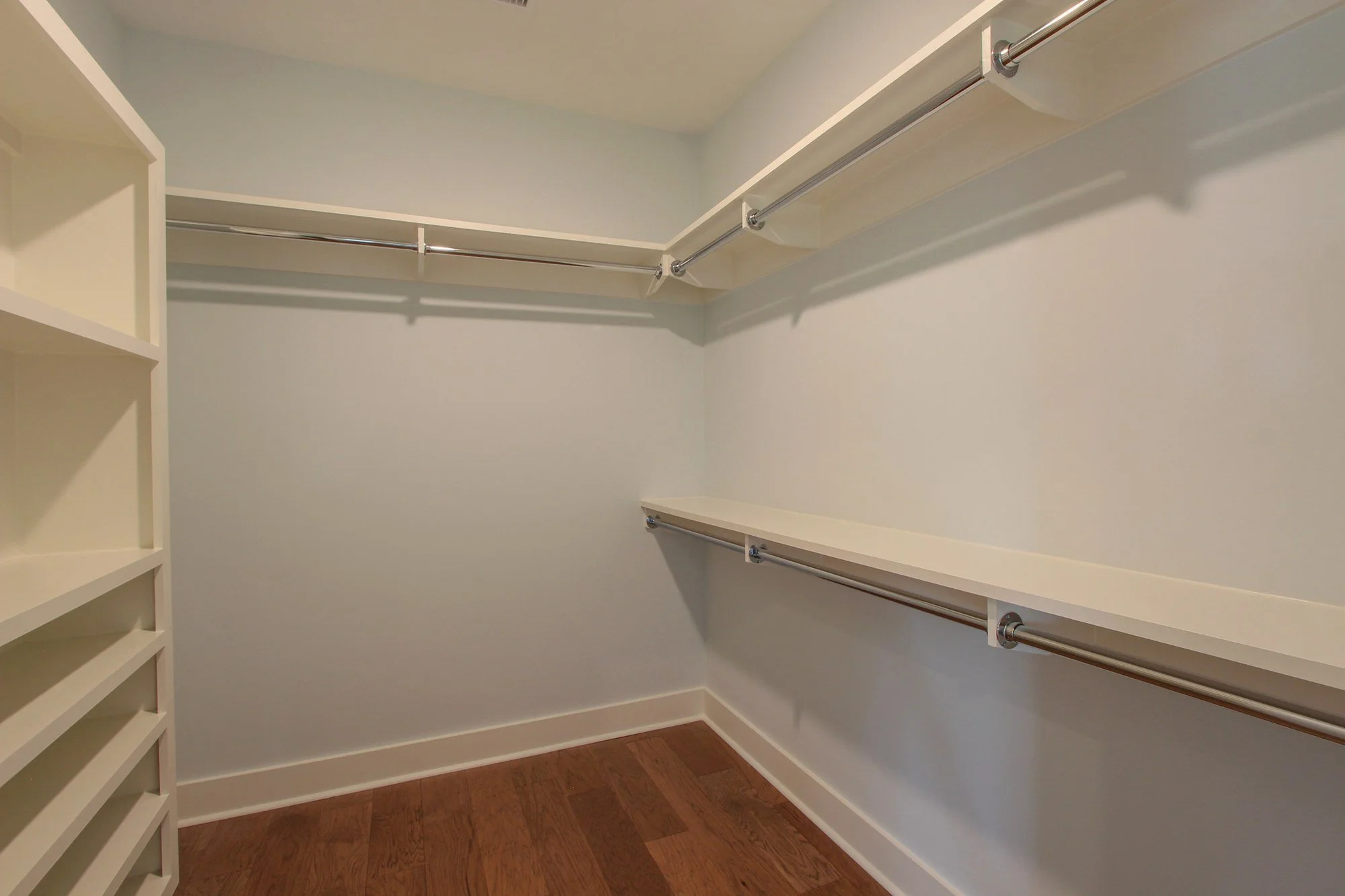 Custom primary walk-in closet with built-in shelving in a Charleston SC luxury home