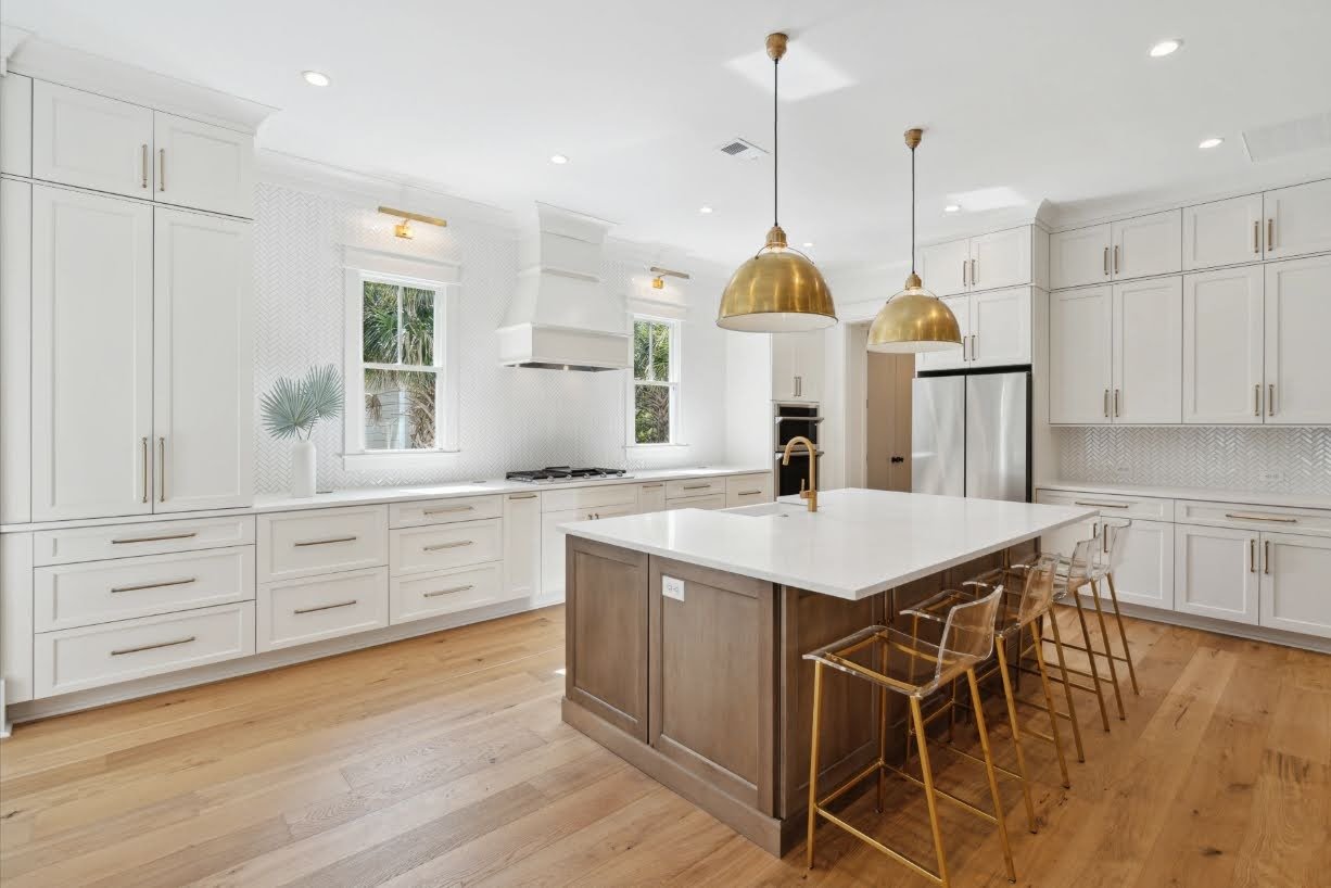 Kitchen range wall with custom hood in a Charleston SC coastal home by Iconic Developments