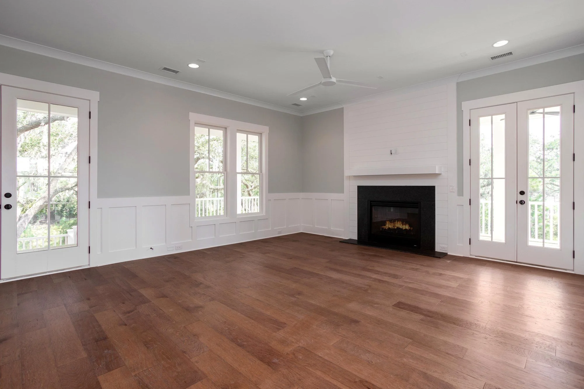 Living room featuring a shiplap fireplace surround in a Johns Island SC custom home