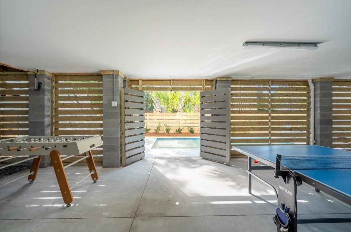 Ground-level game room in an elevated Isle of Palms SC home by Iconic Developments