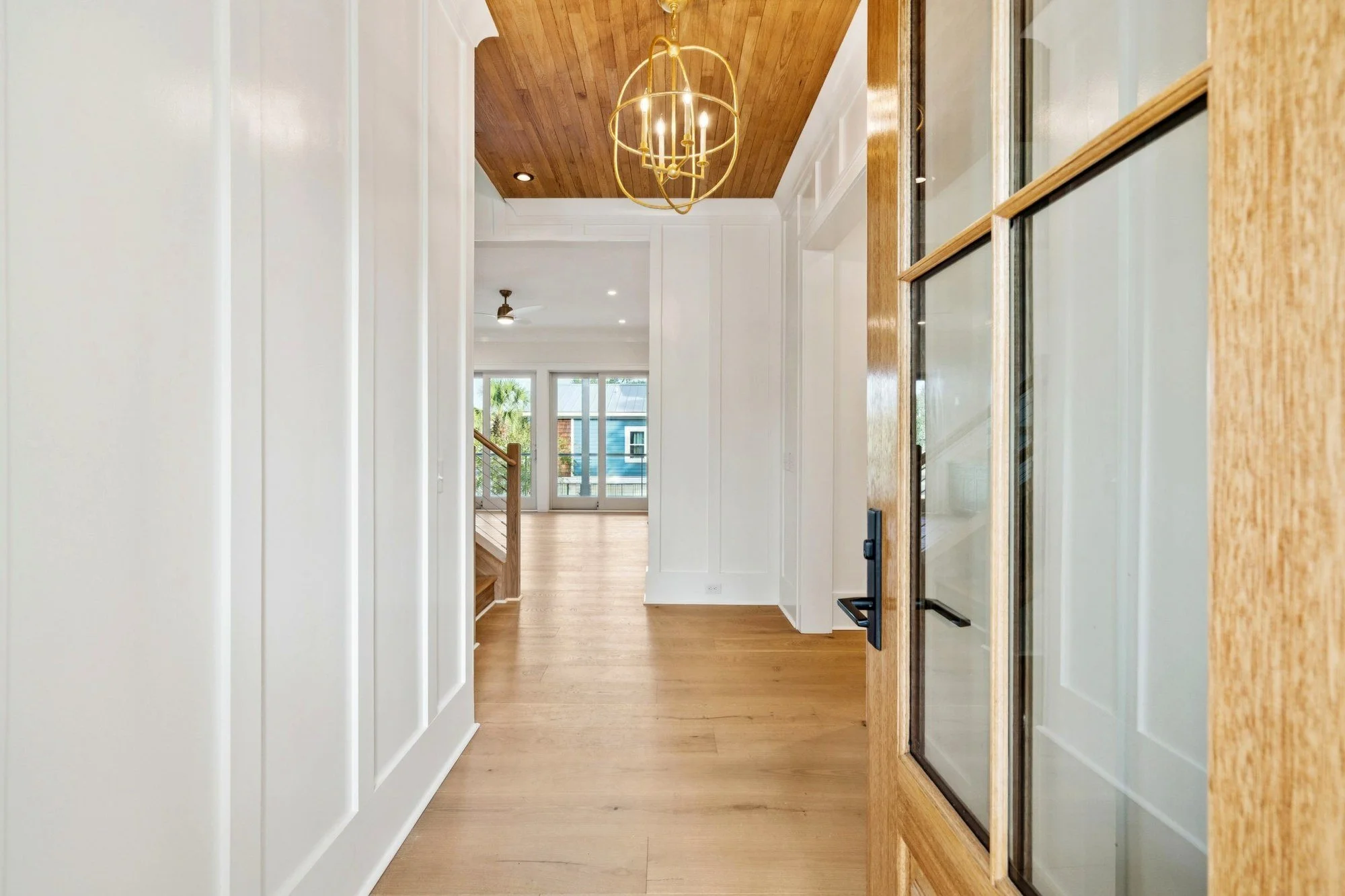 Hallway with wide plank white oak floors in an Isle of Palms SC luxury custom home