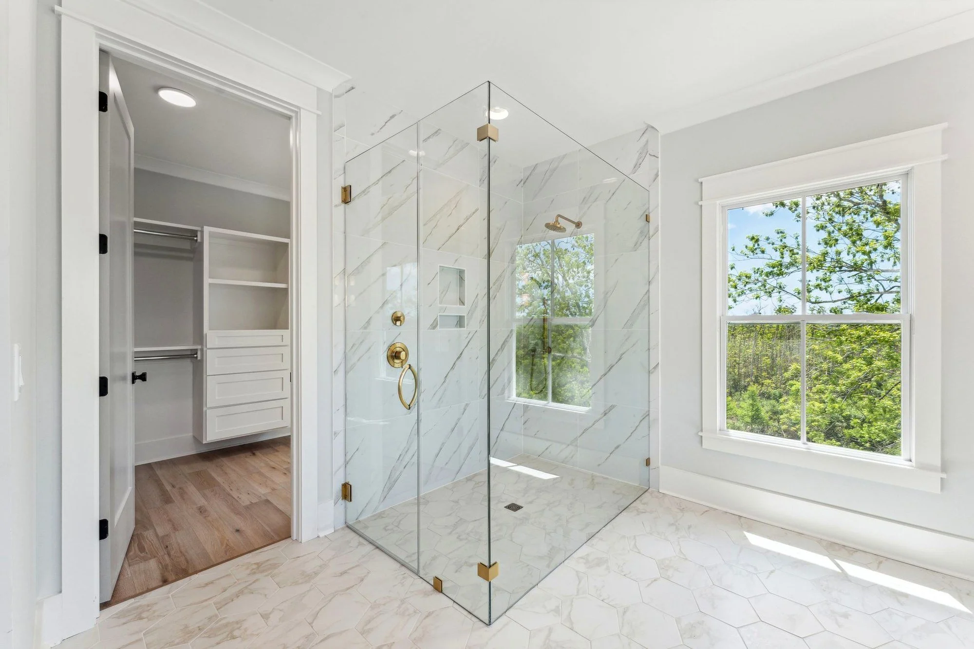 Frameless glass walk-in shower with custom tilework in a Charleston SC luxury home