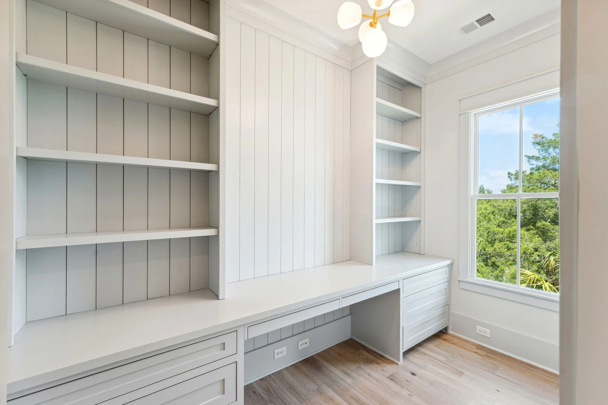 Home study with built-in desk and shiplap shelving in a Daniel Island SC custom home