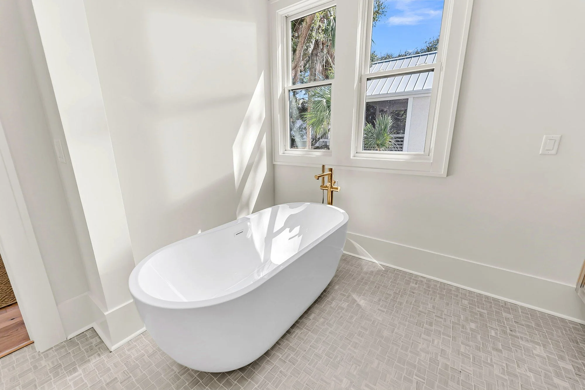 Owners bath with freestanding soaking tub in an Isle of Palms SC luxury custom home