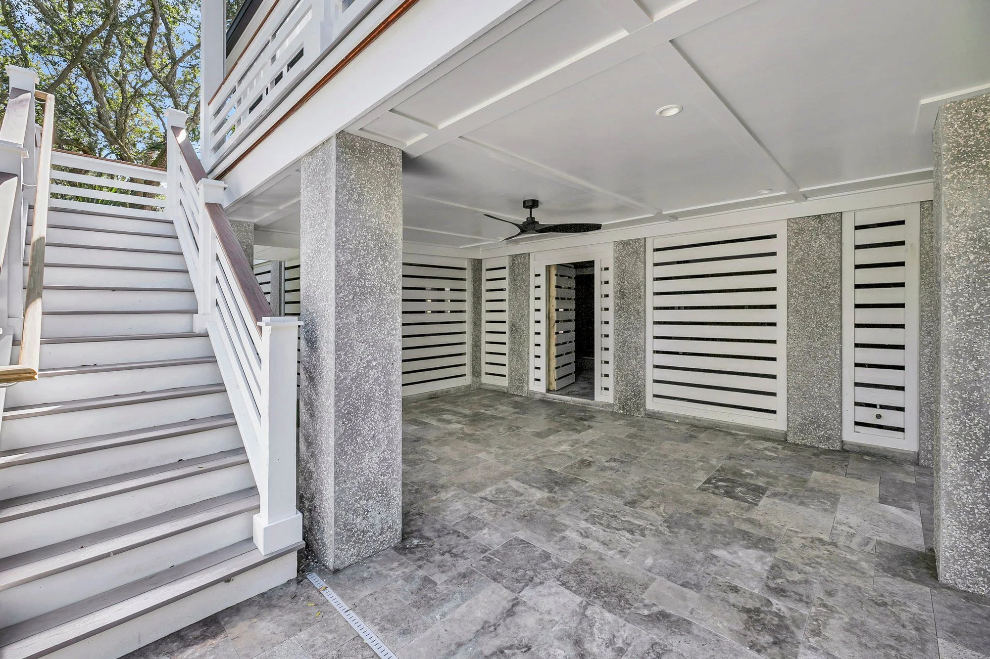 Ground-level covered terrace and outdoor living space on an Isle of Palms SC custom home