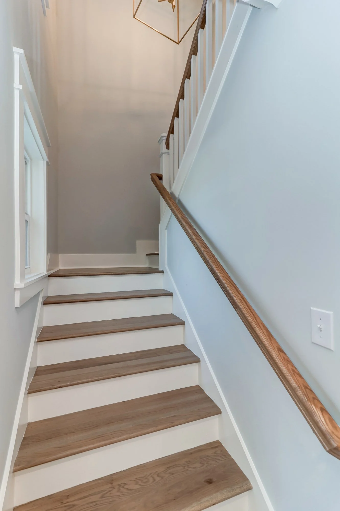 Custom white oak staircase in an Old Village Mount Pleasant SC luxury custom home