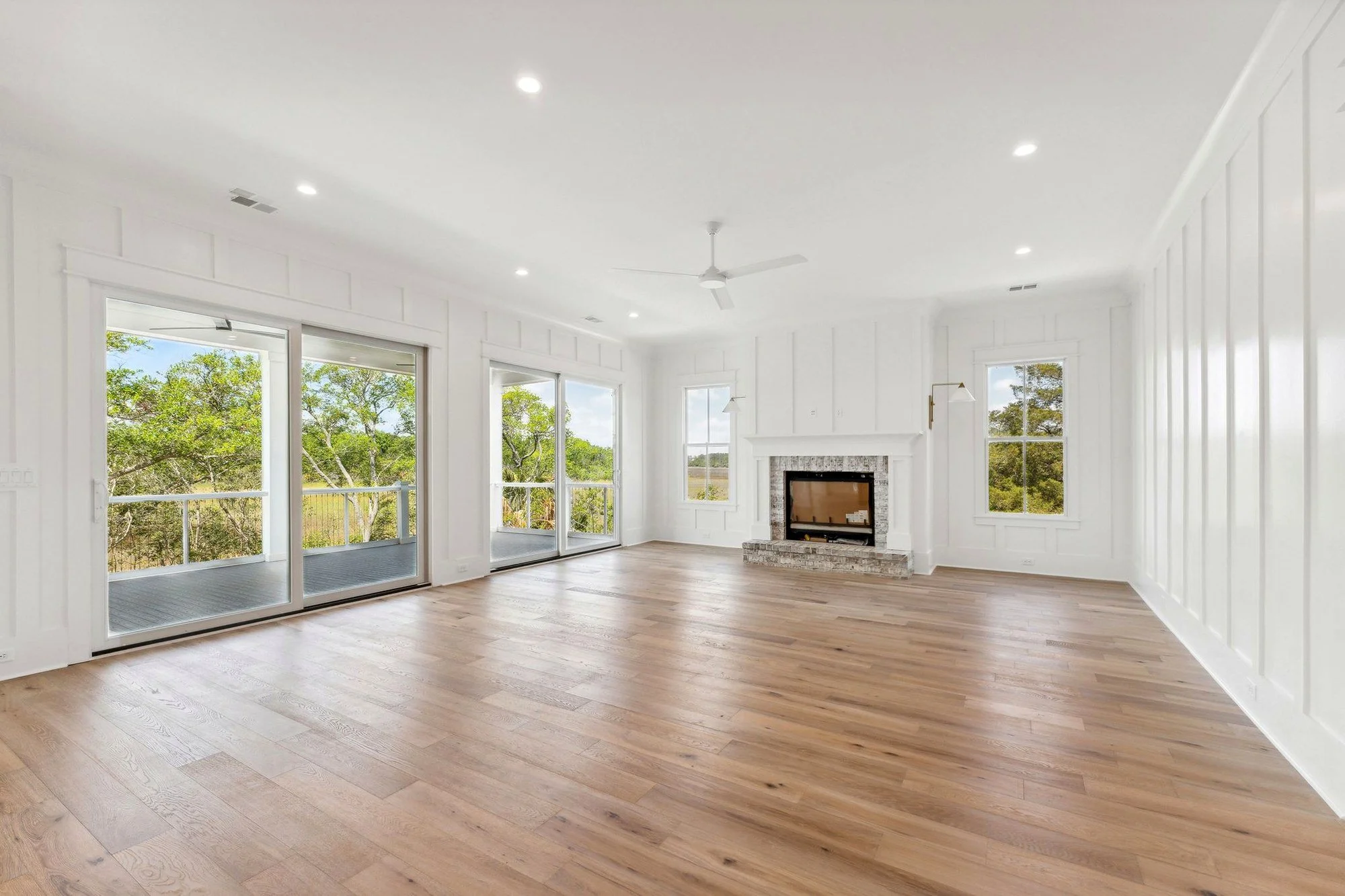 Open-concept great room with custom fireplace built on Daniel Island SC by Iconic Developments