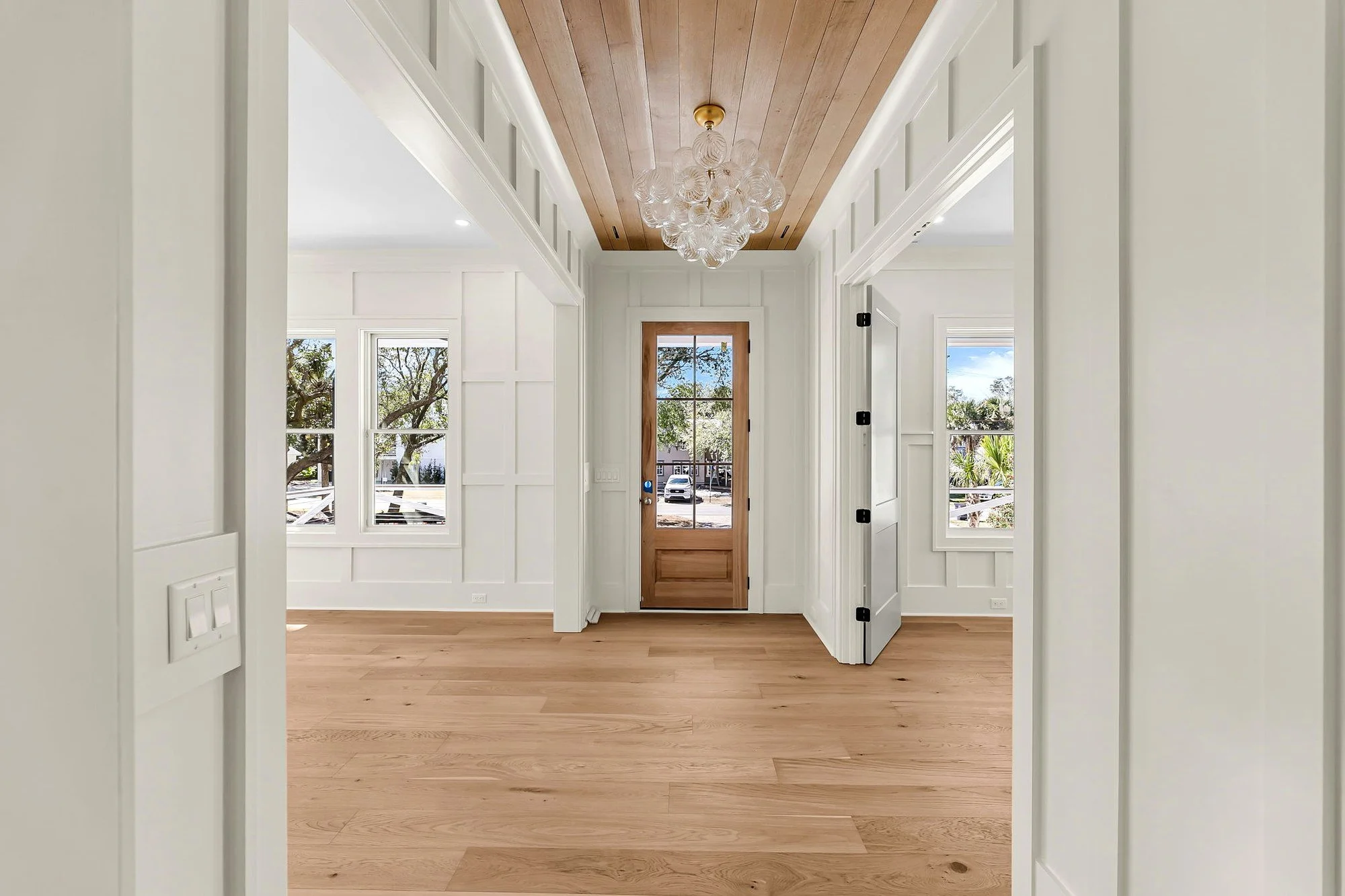 Entry hall with wood plank ceiling detail in an Isle of Palms SC home by Iconic Developments