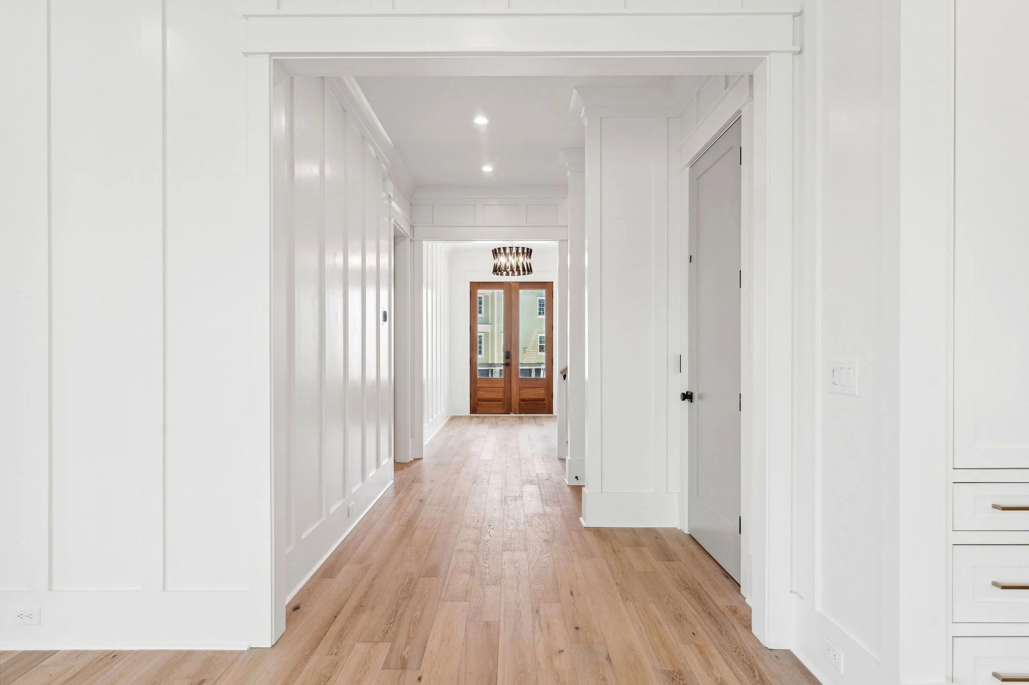 Central hallway with white oak flooring in a custom Daniel Island SC coastal home build