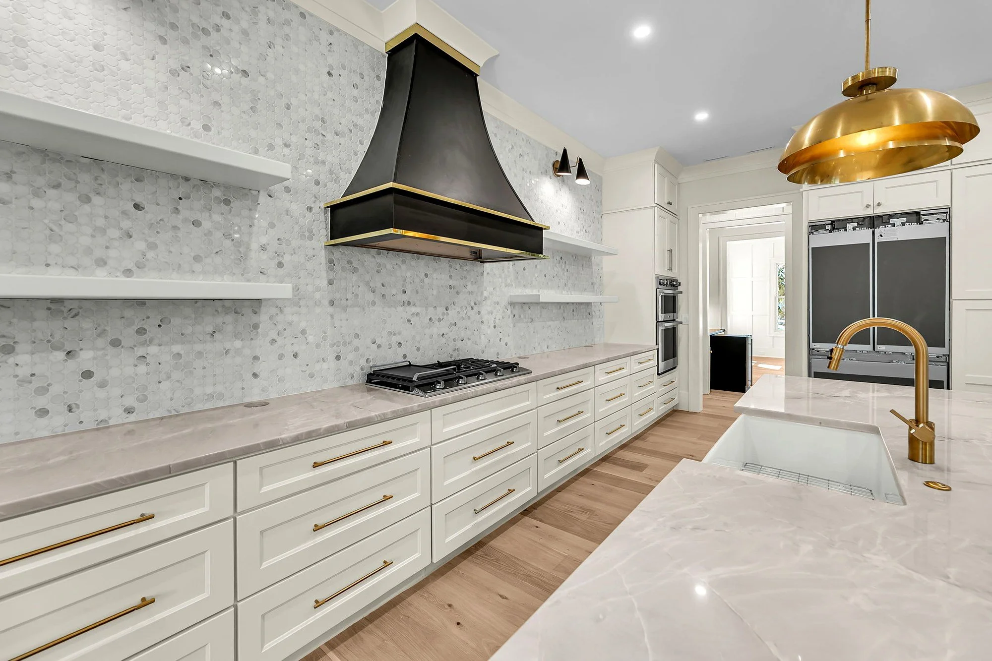 Gourmet kitchen range wall with custom hood on Isle of Palms SC by Iconic Developments