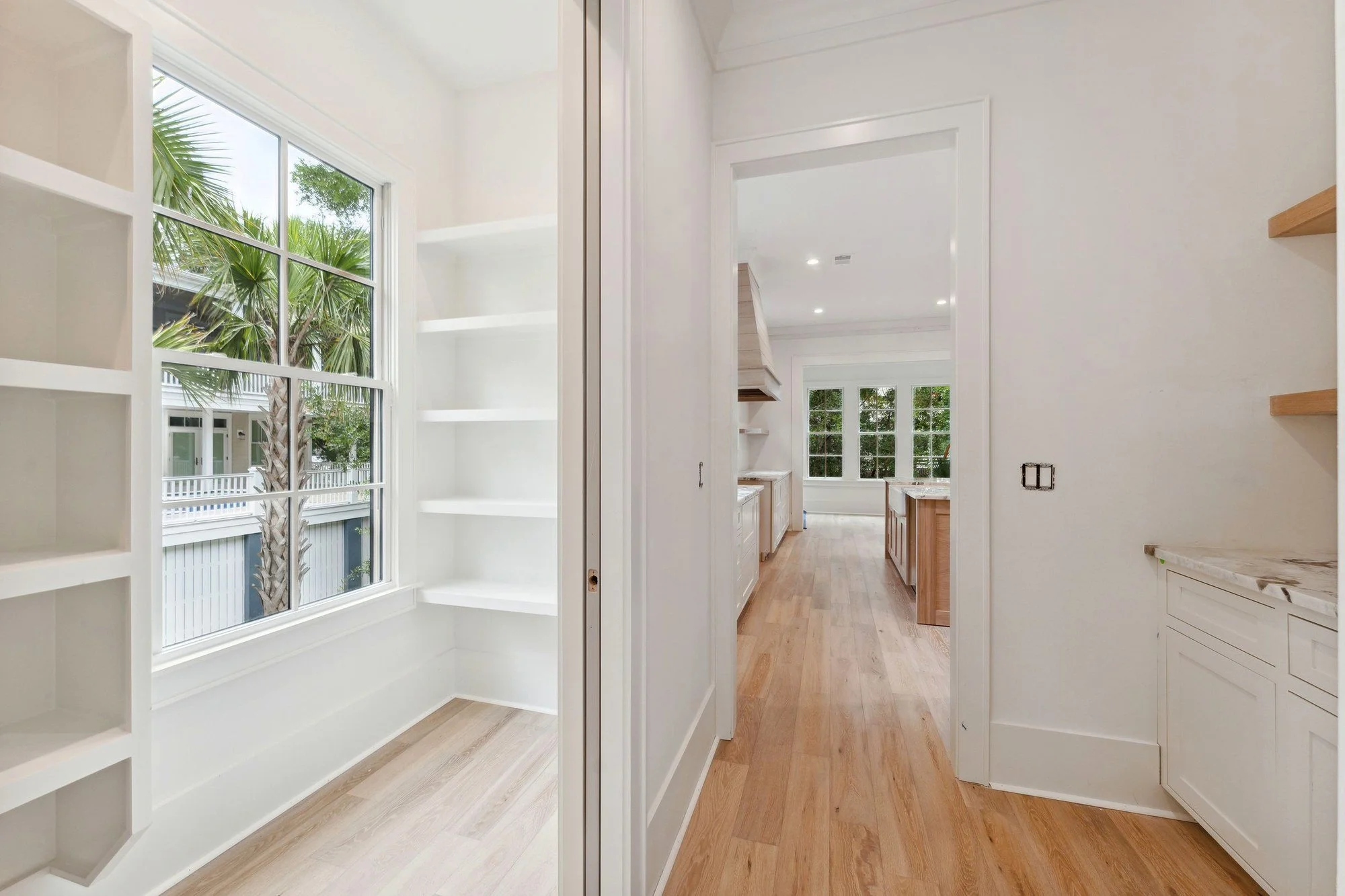 Hallway with built-in shelving and a long sightline to the rear of the house.