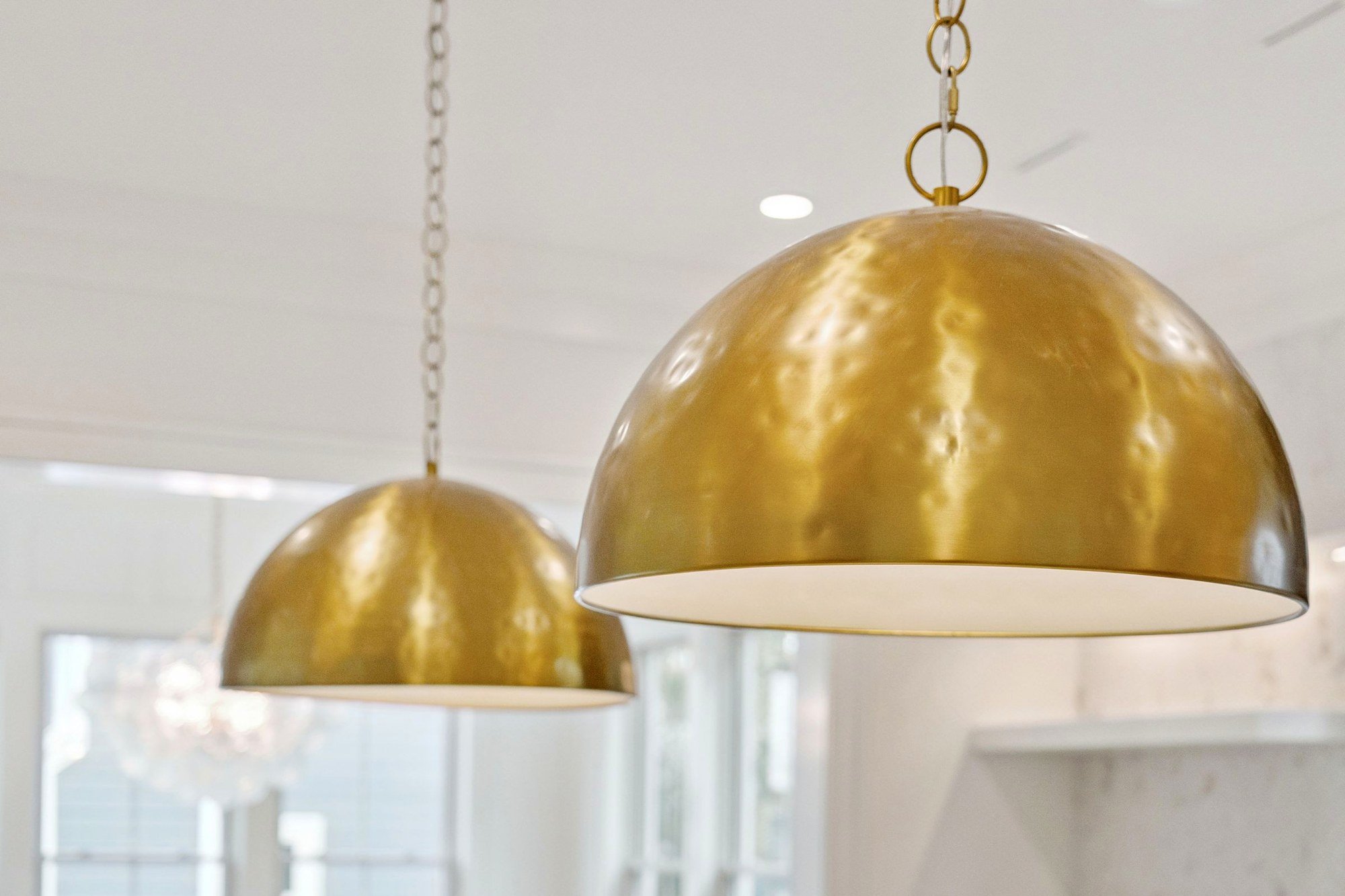 Brass dome pendants above the kitchen island of an Isle of Palms SC custom home build
