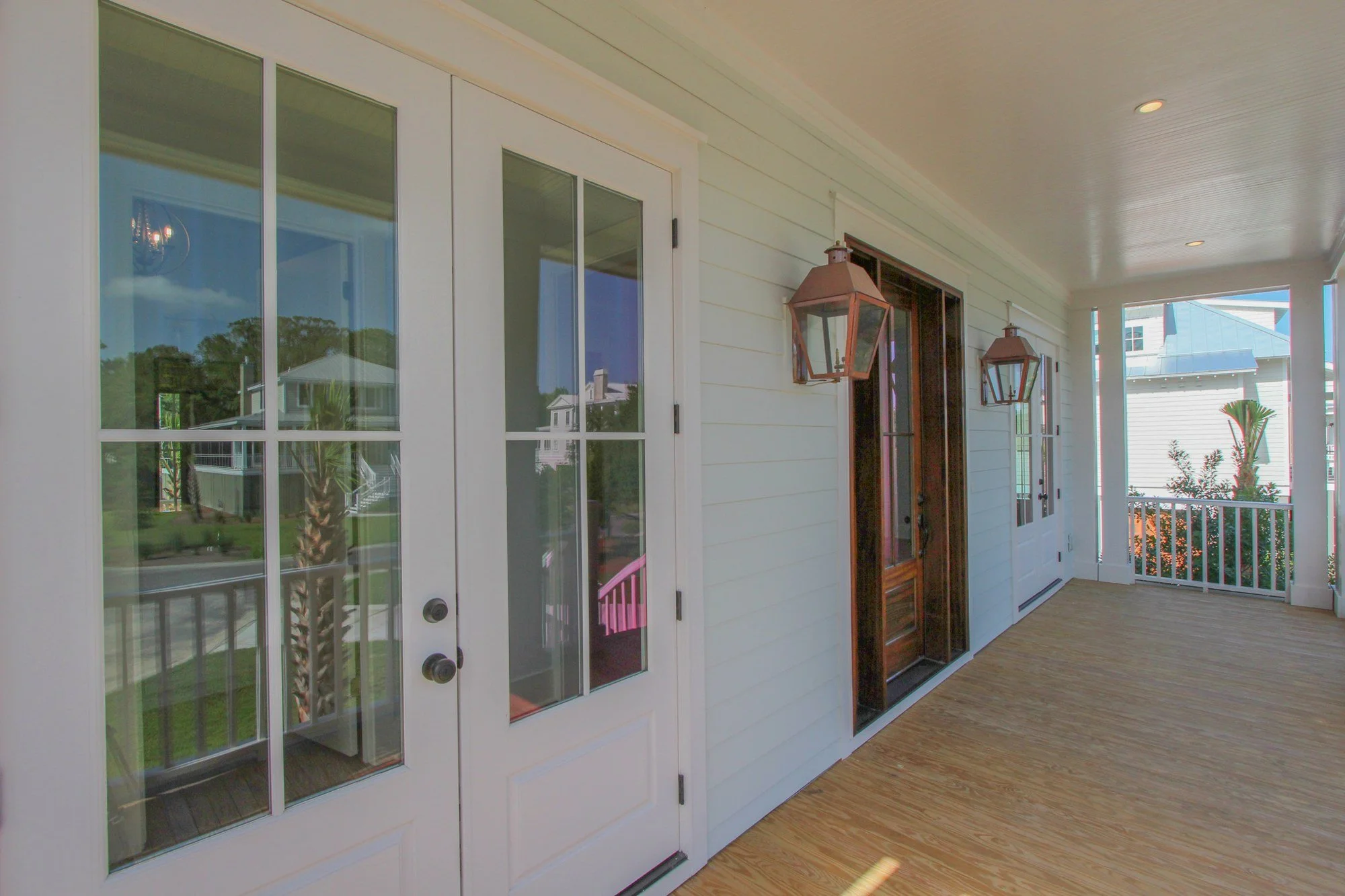 Front porch with gas lanterns and beadboard ceiling on a Johns Island SC custom home