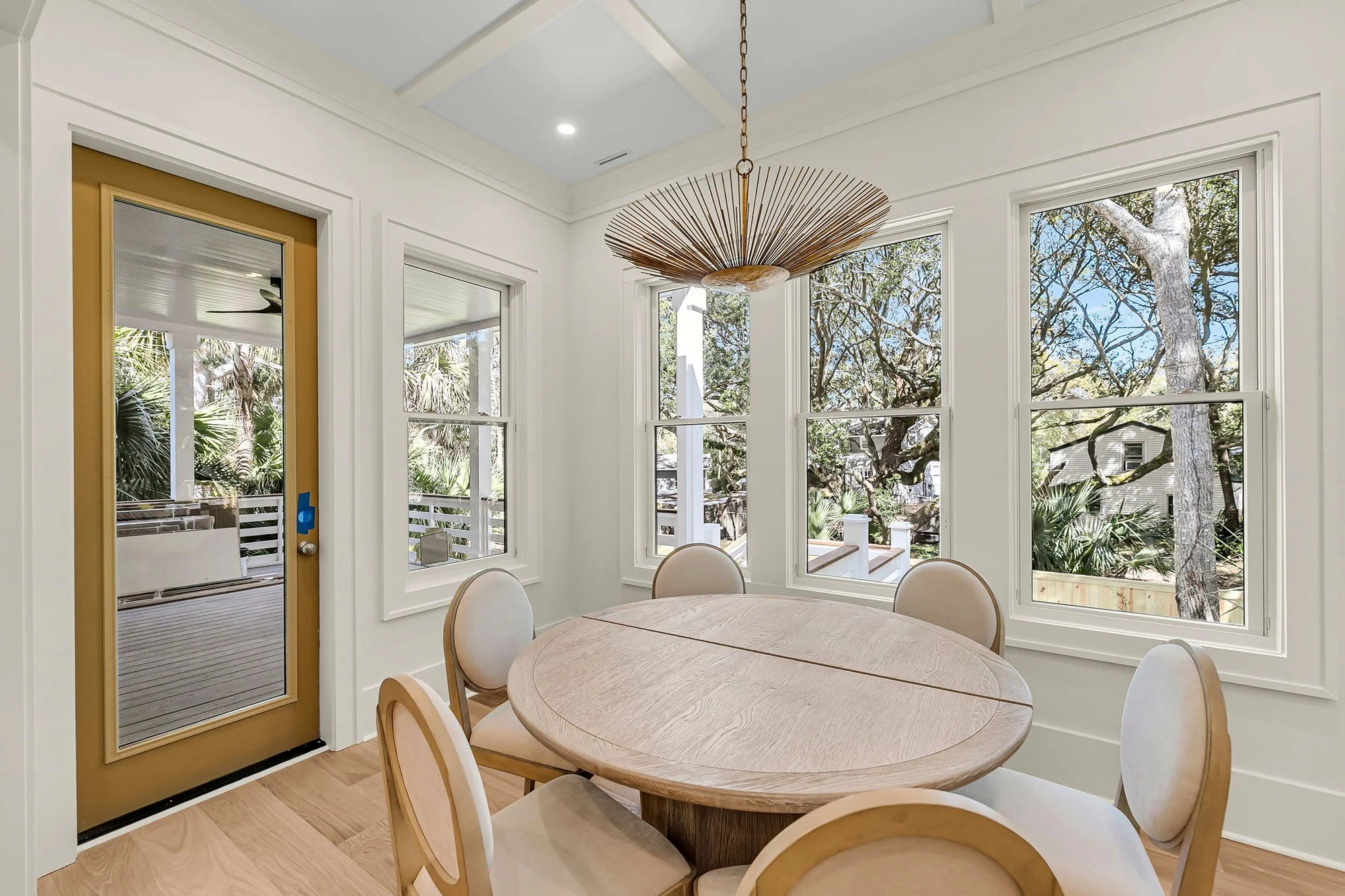 Dining room with woven chandelier in an Isle of Palms SC home by Iconic Developments