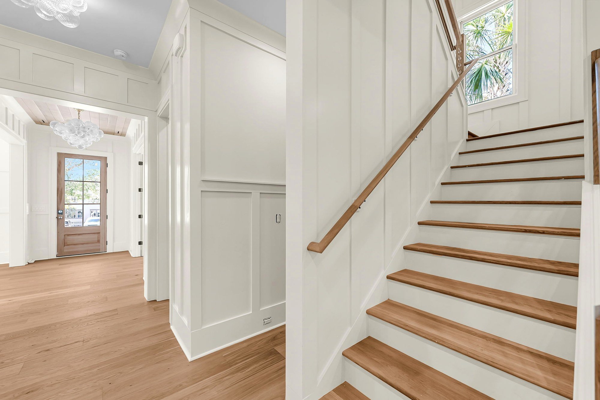 Custom white oak staircase in a luxury Isle of Palms SC home built by Iconic Developments