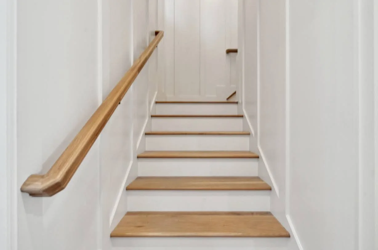 White oak stair handrail detail in a luxury custom home built on Isle of Palms SC