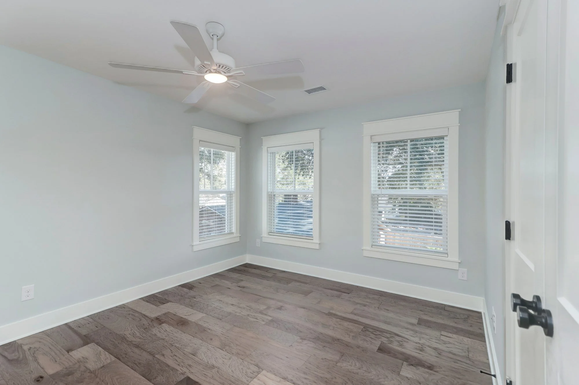 Guest bedroom with corner windows in an Old Village Mount Pleasant SC custom home build