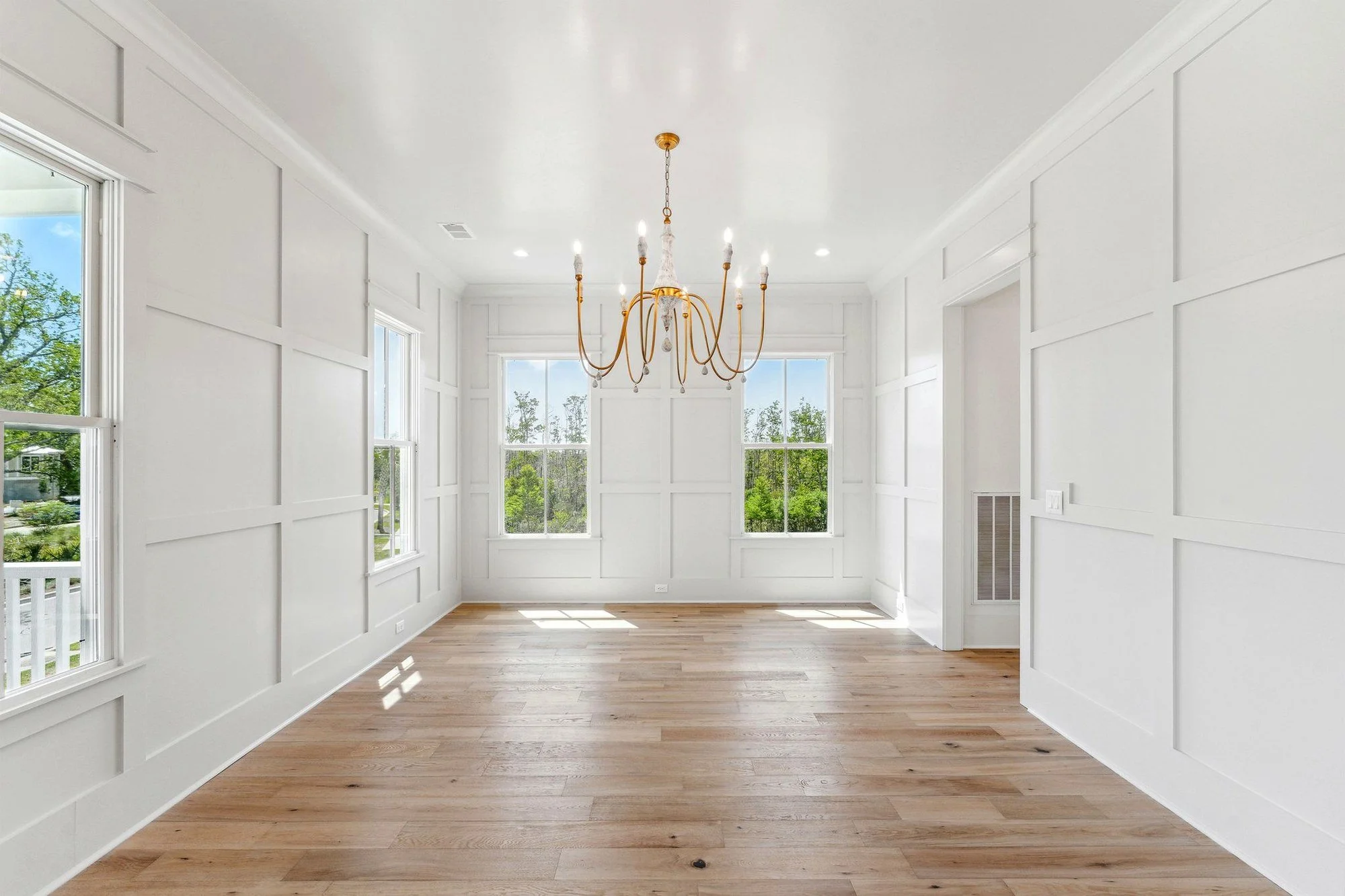 Paneled sitting room with a wall of windows in a Charleston SC luxury custom home build